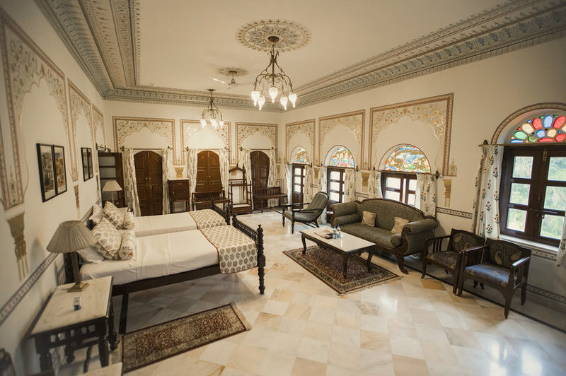 a room with two beds and a couch