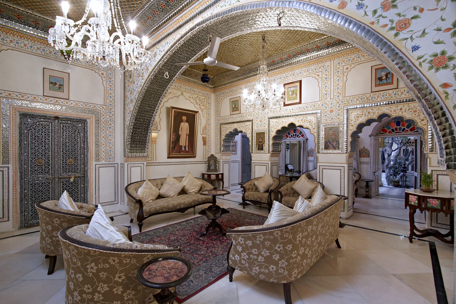 a room with couches and a chandelier