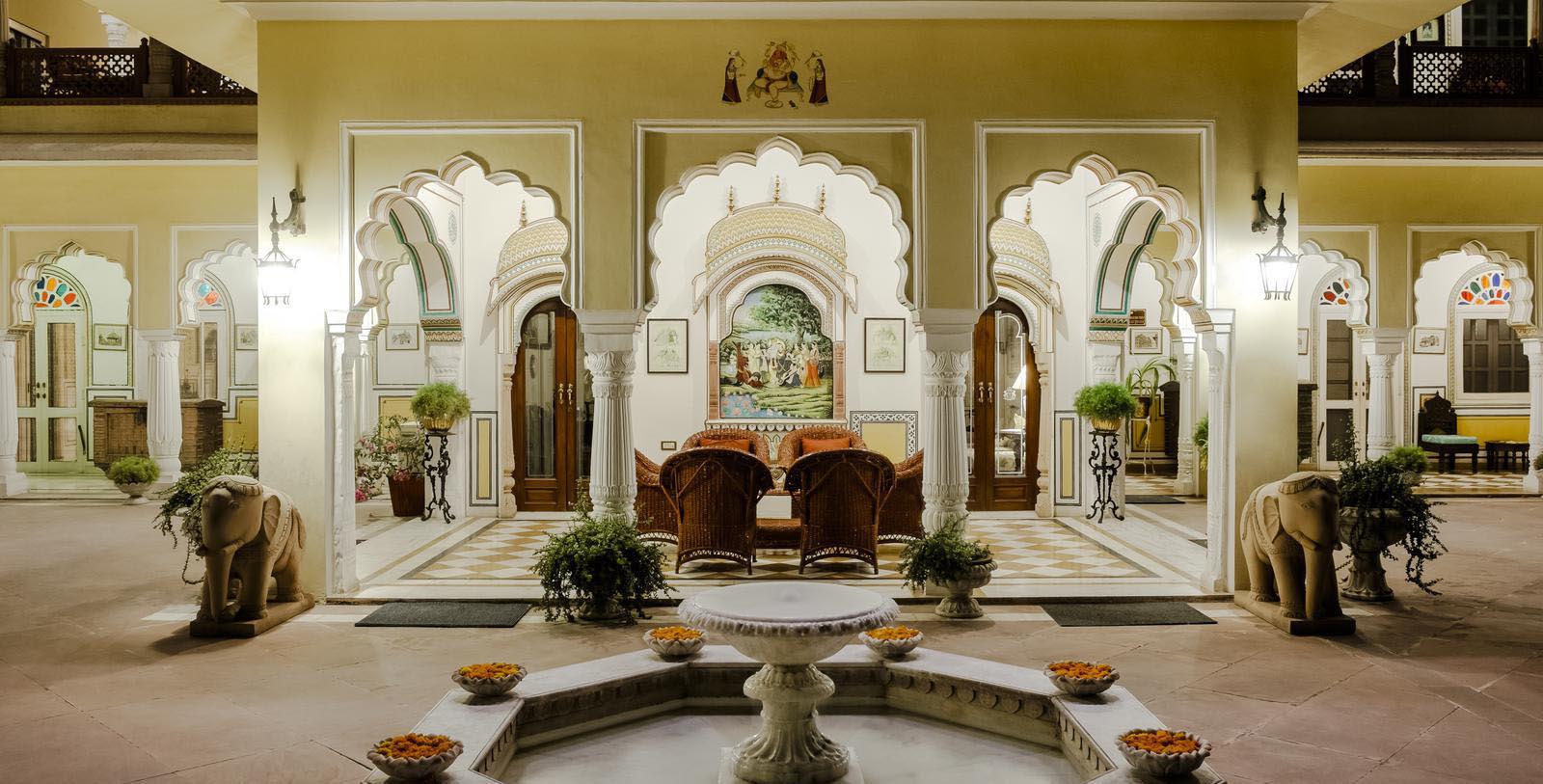 a room with a fountain and chairs