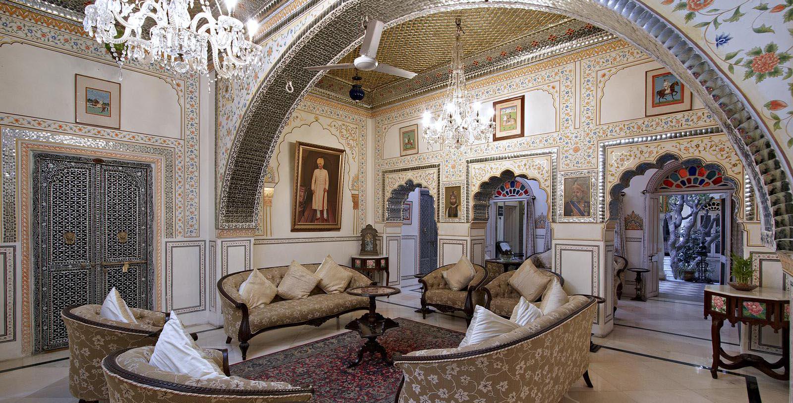 a room with a chandelier and couches