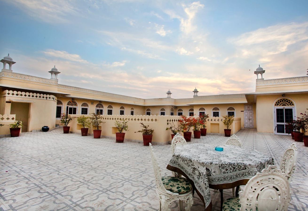 a patio with a table and chairs