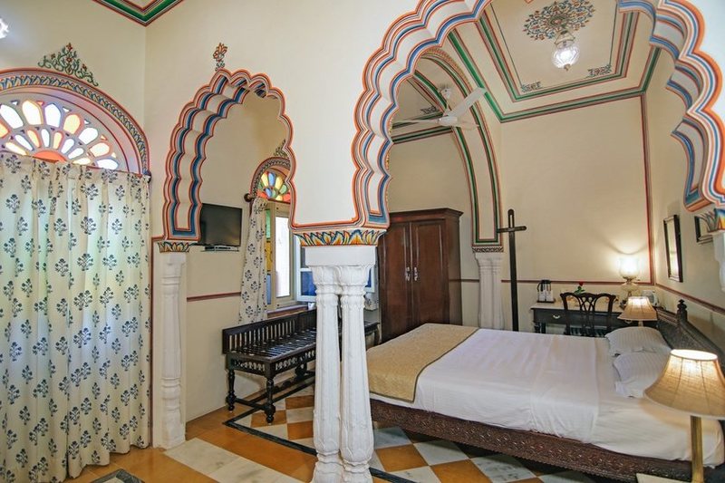 a room with a bed and a piano