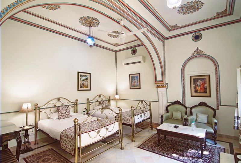 a room with two beds and a table