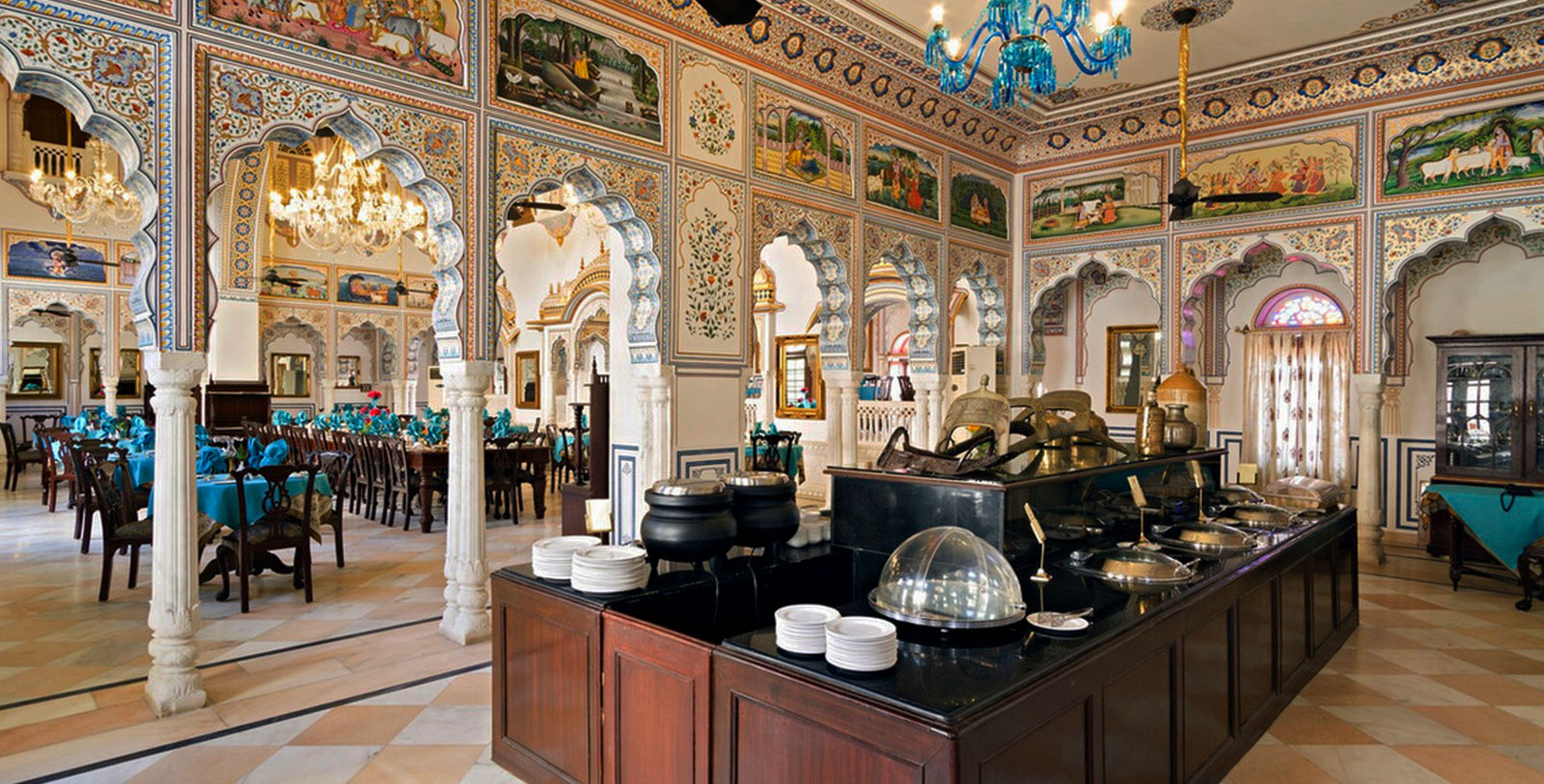 a restaurant with many dishes on the counter