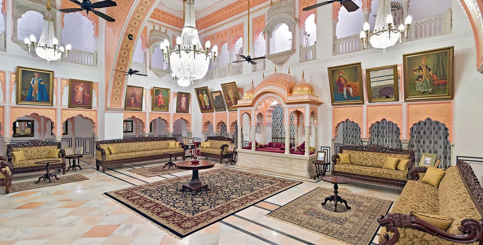 a room with a chandelier and couches