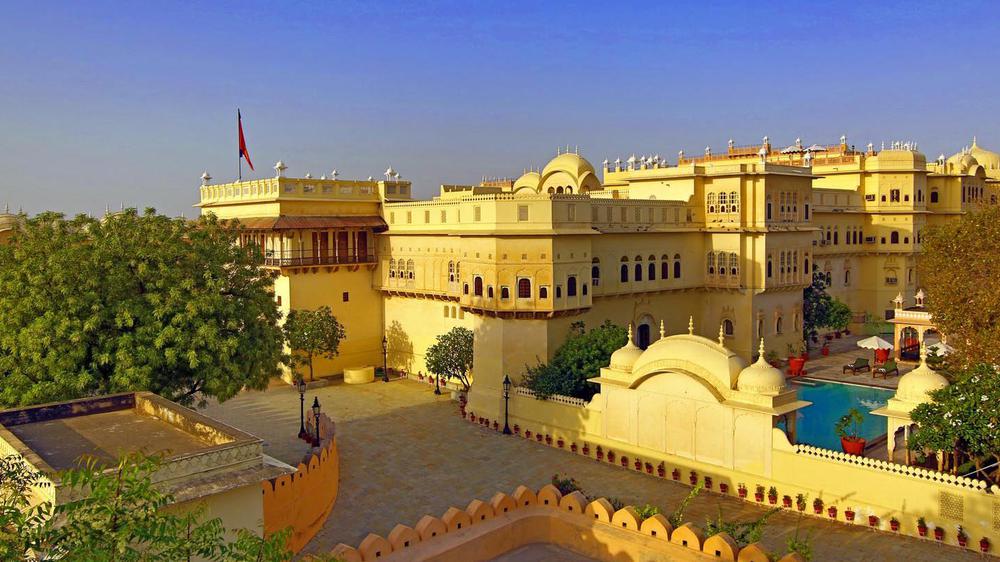 a large yellow building with a flag on the roof