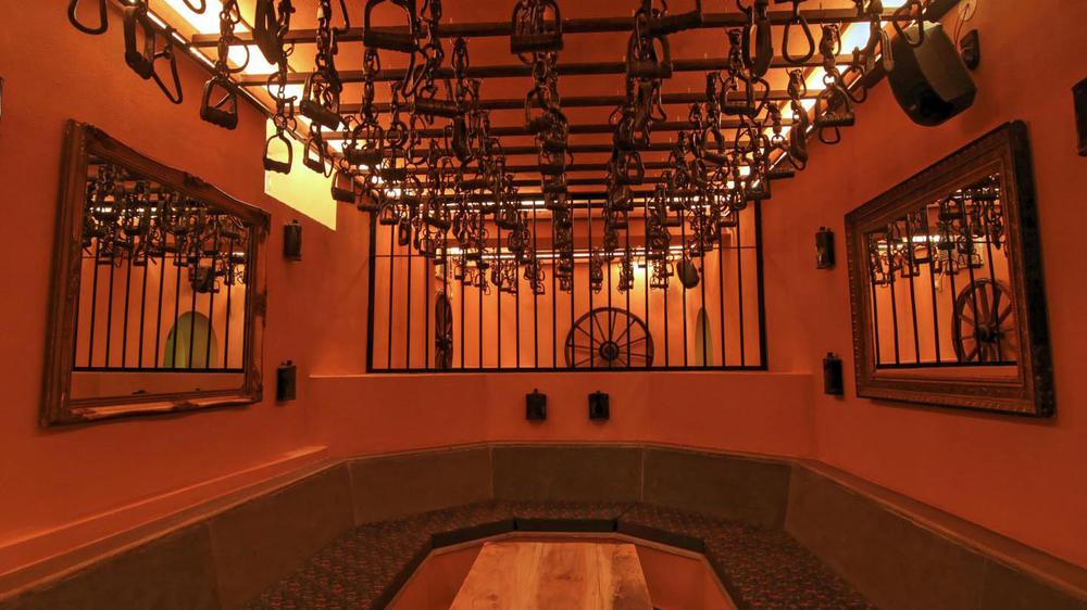 a room with horse harnesses from the ceiling