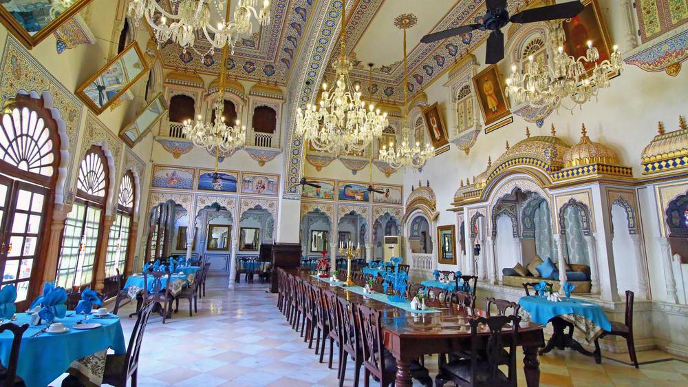 a large room with chandeliers and tables