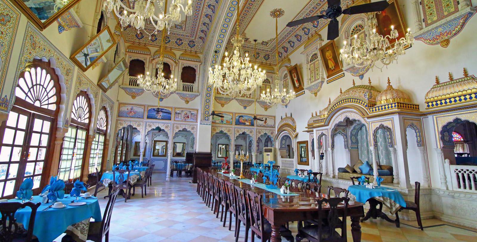 a large room with chandeliers and tables
