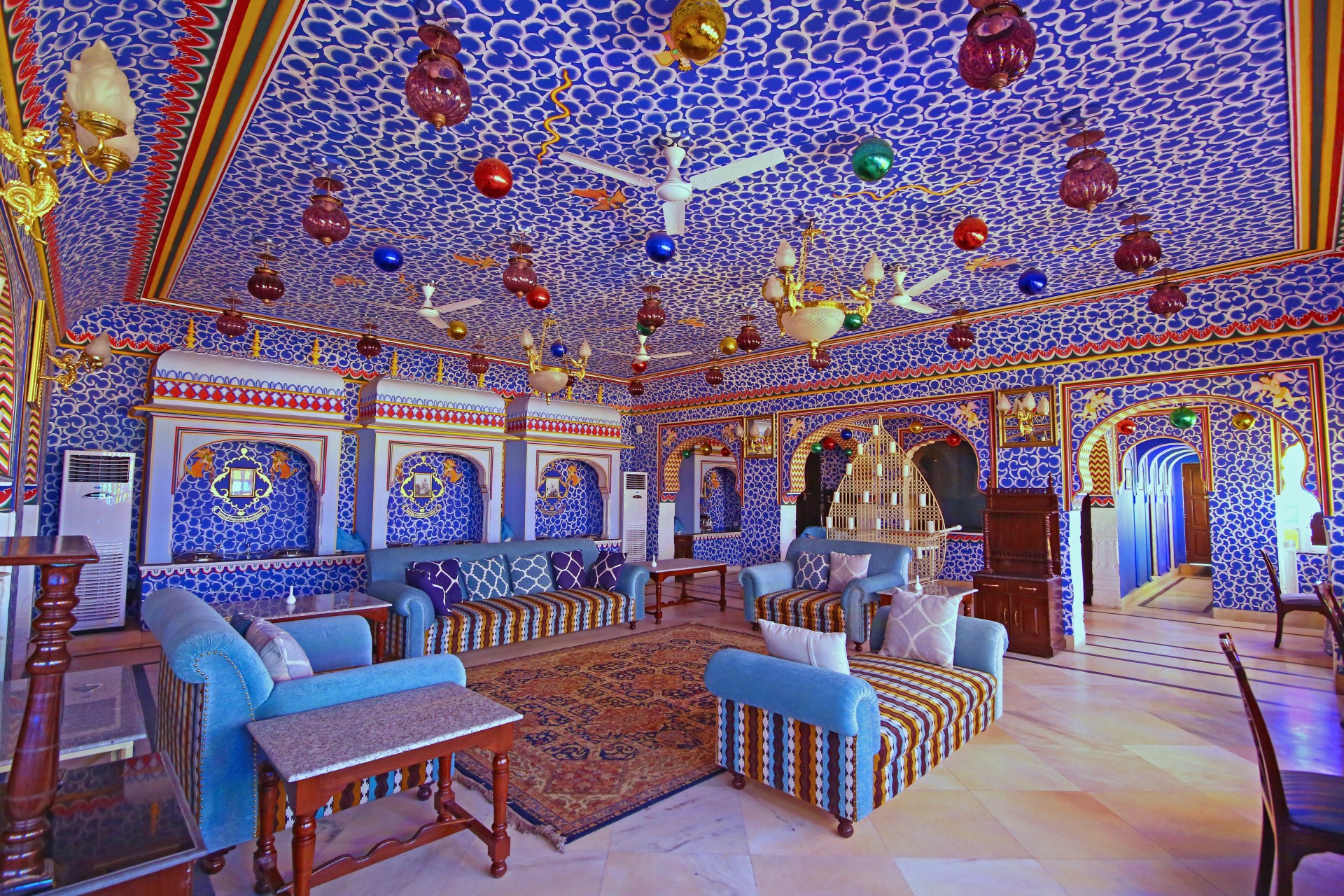 a room with blue and white patterned walls and a couch