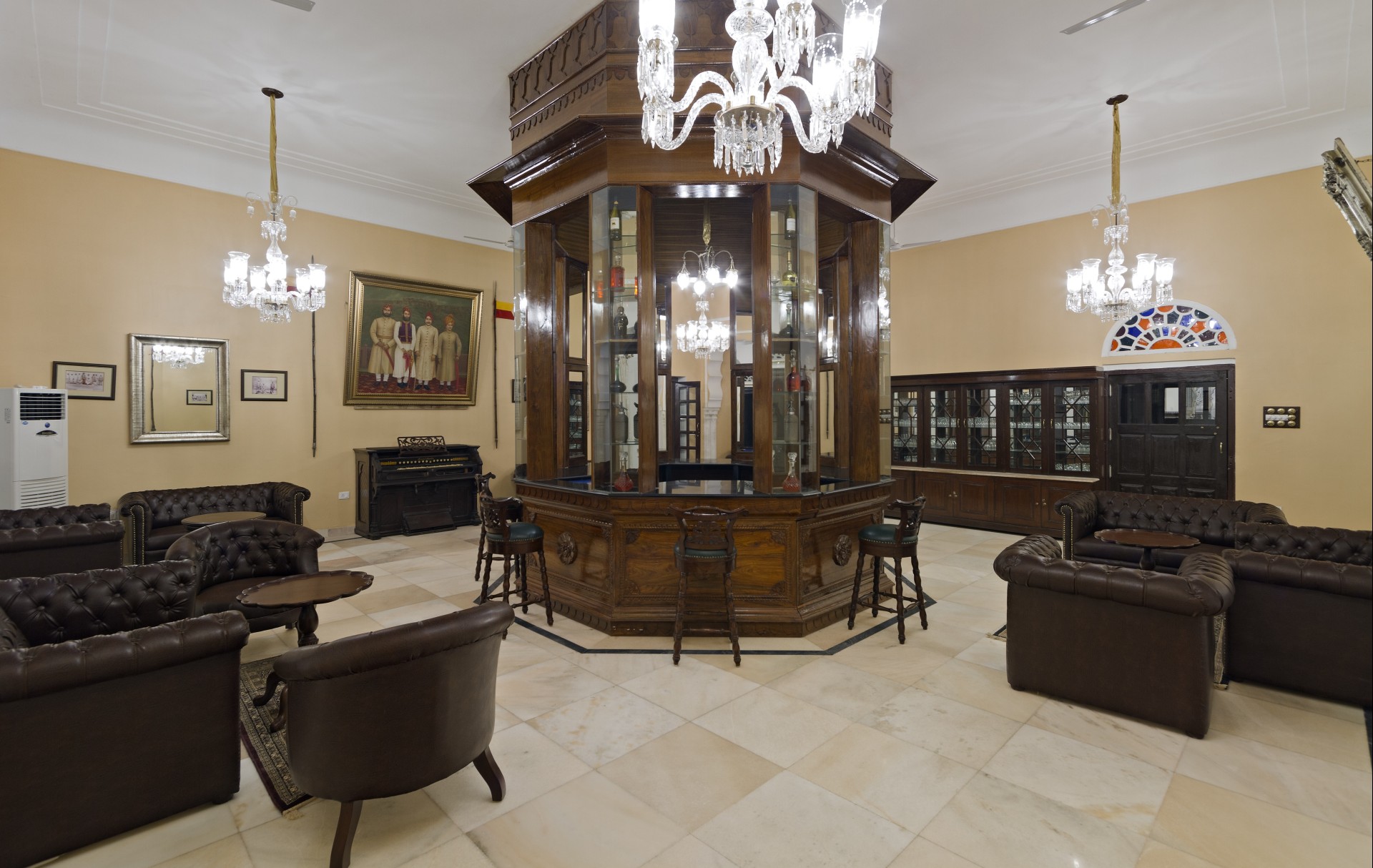 a room with a chandelier and a glass case