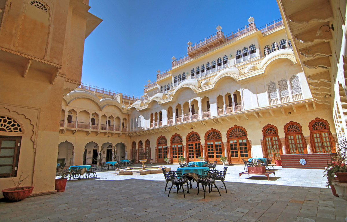 a courtyard with tables and chairs