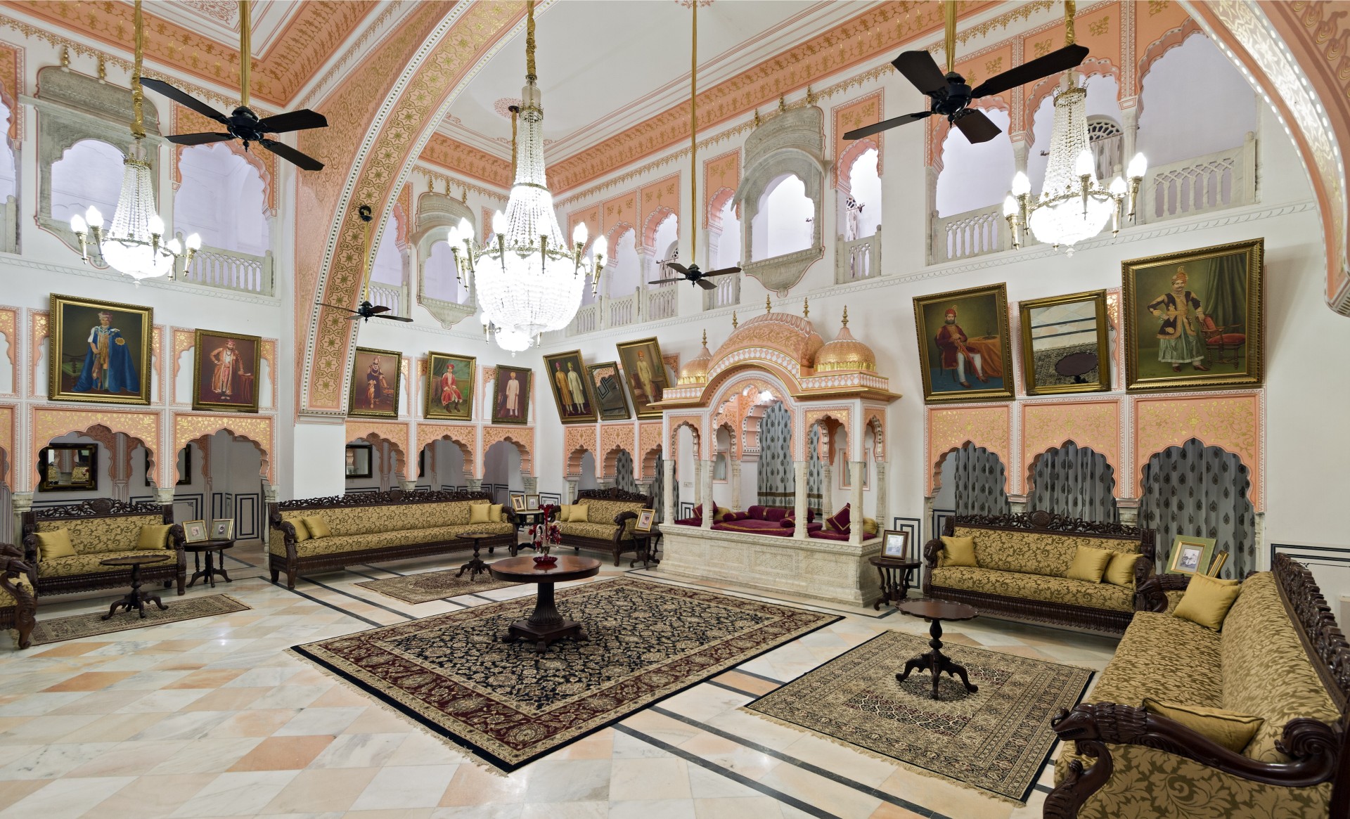 a room with a chandelier and couches