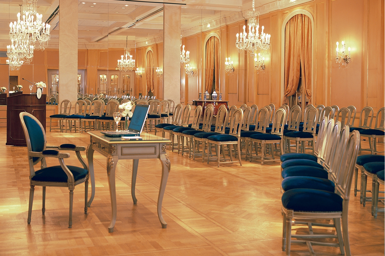 a room with many chairs and a laptop