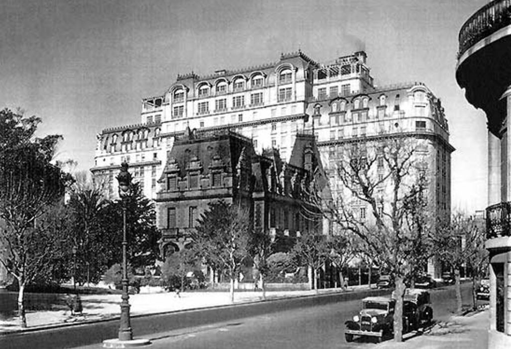 a large building with a street and trees