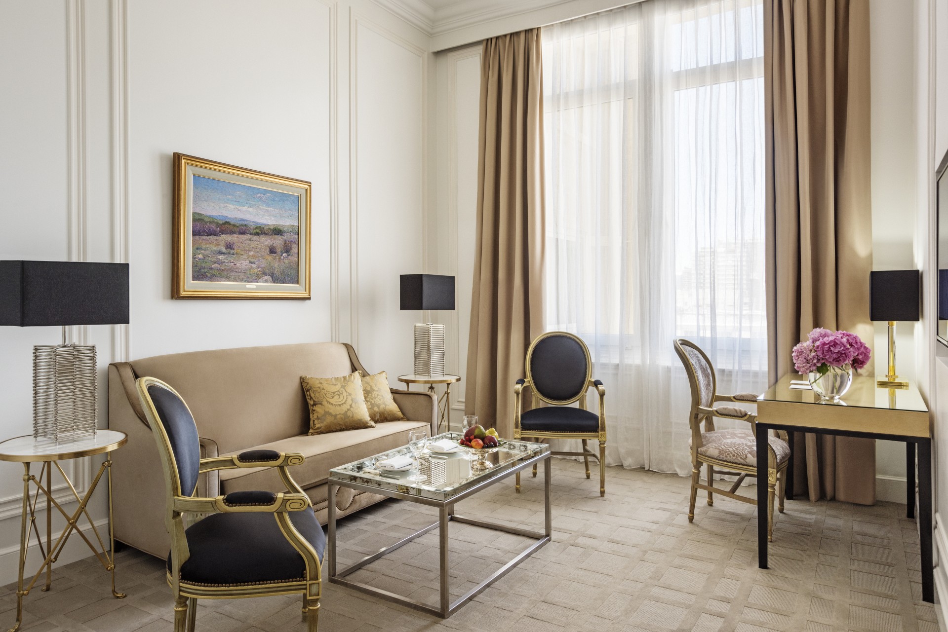 a room with a couch and chairs