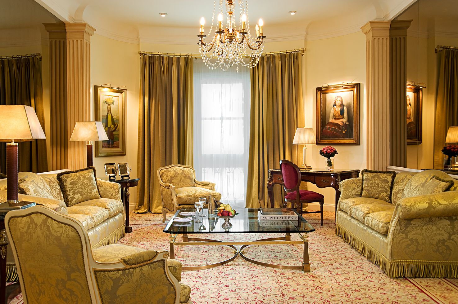 a room with a chandelier and couches
