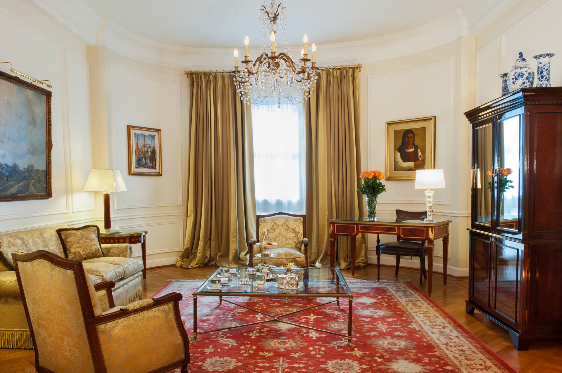 a living room with a chandelier and a table