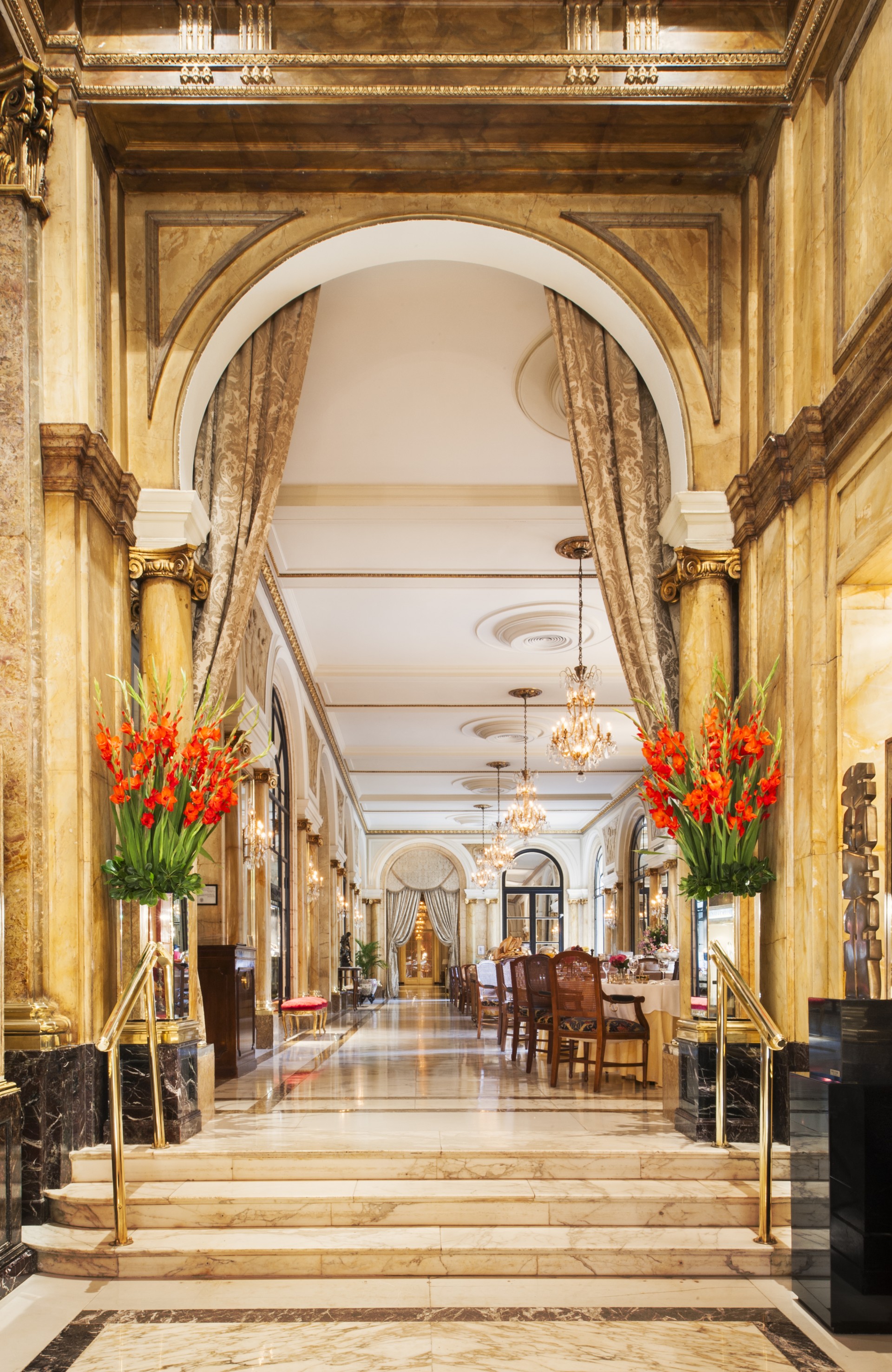 a hallway with tables and chairs