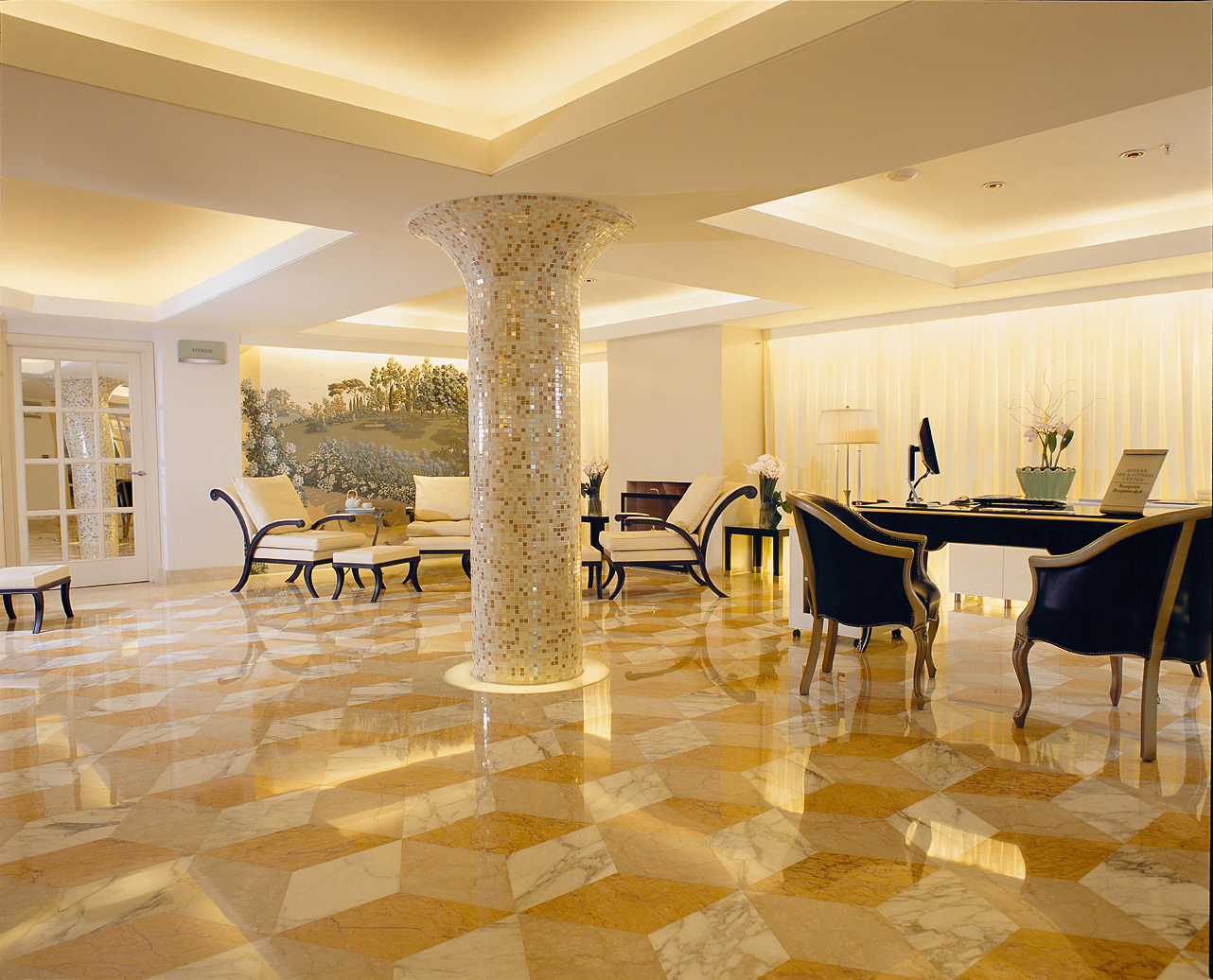 a room with a marble floor and a table and chairs