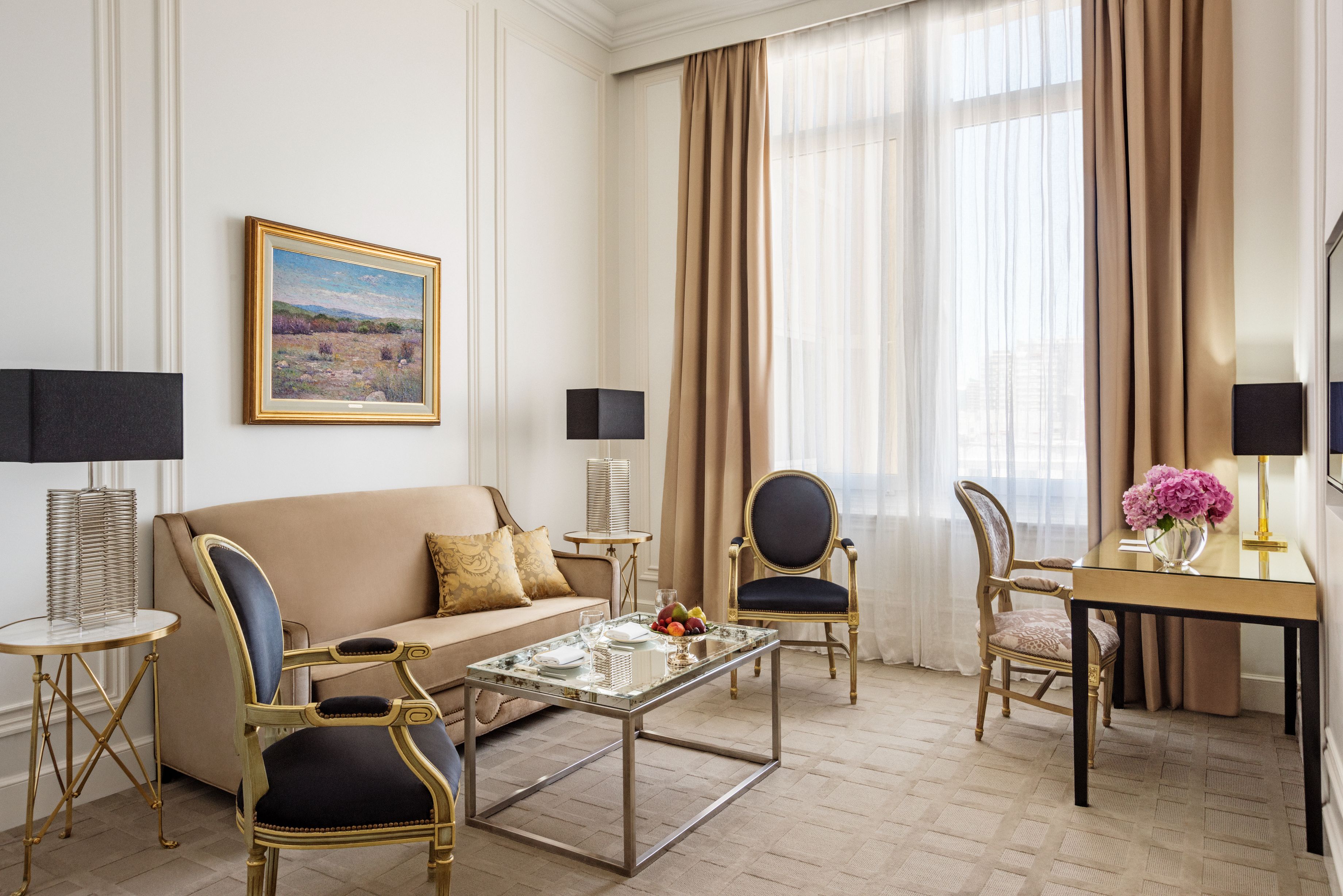 a room with a couch and chairs
