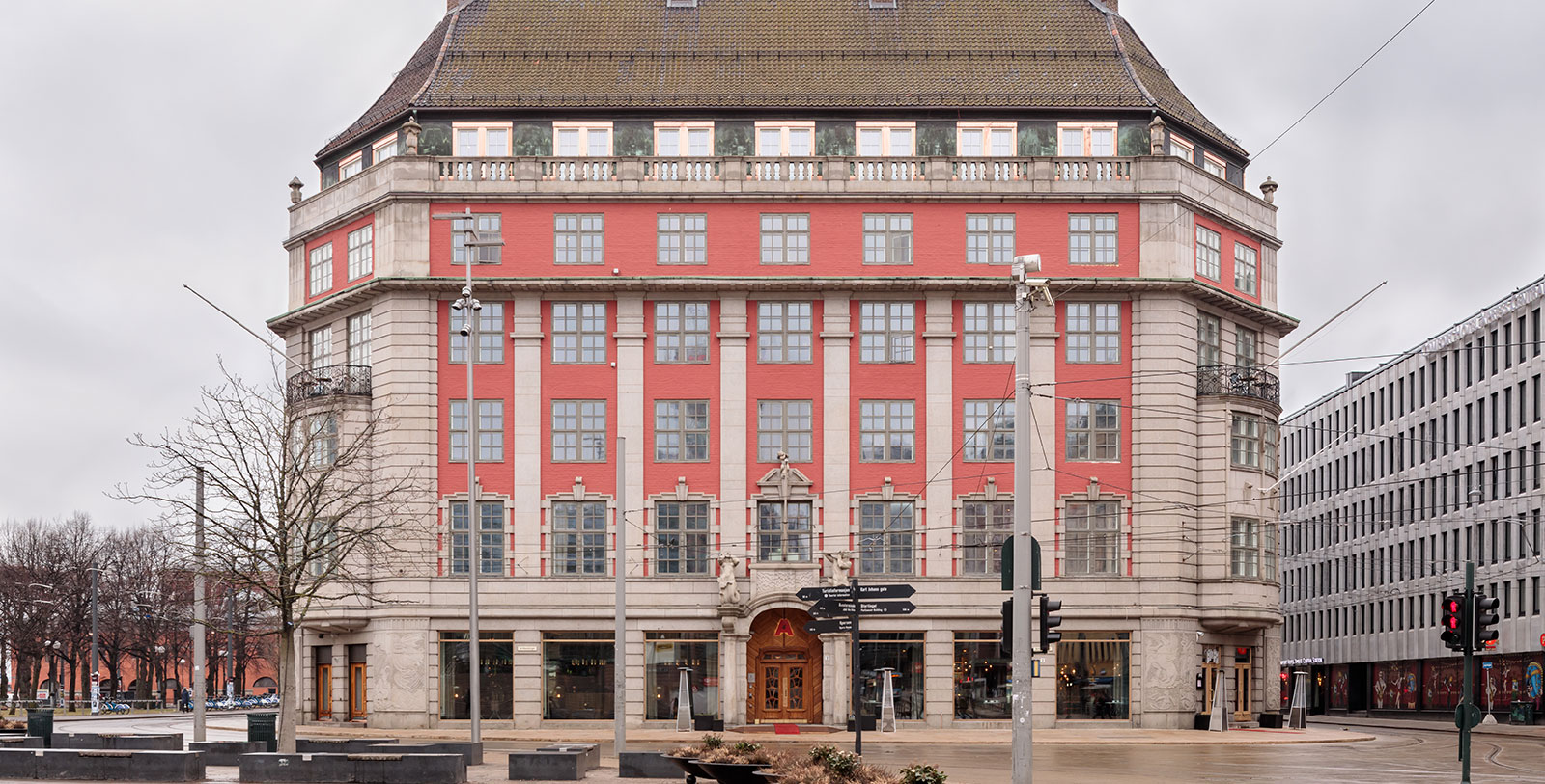 a building with a red wall and a street sign