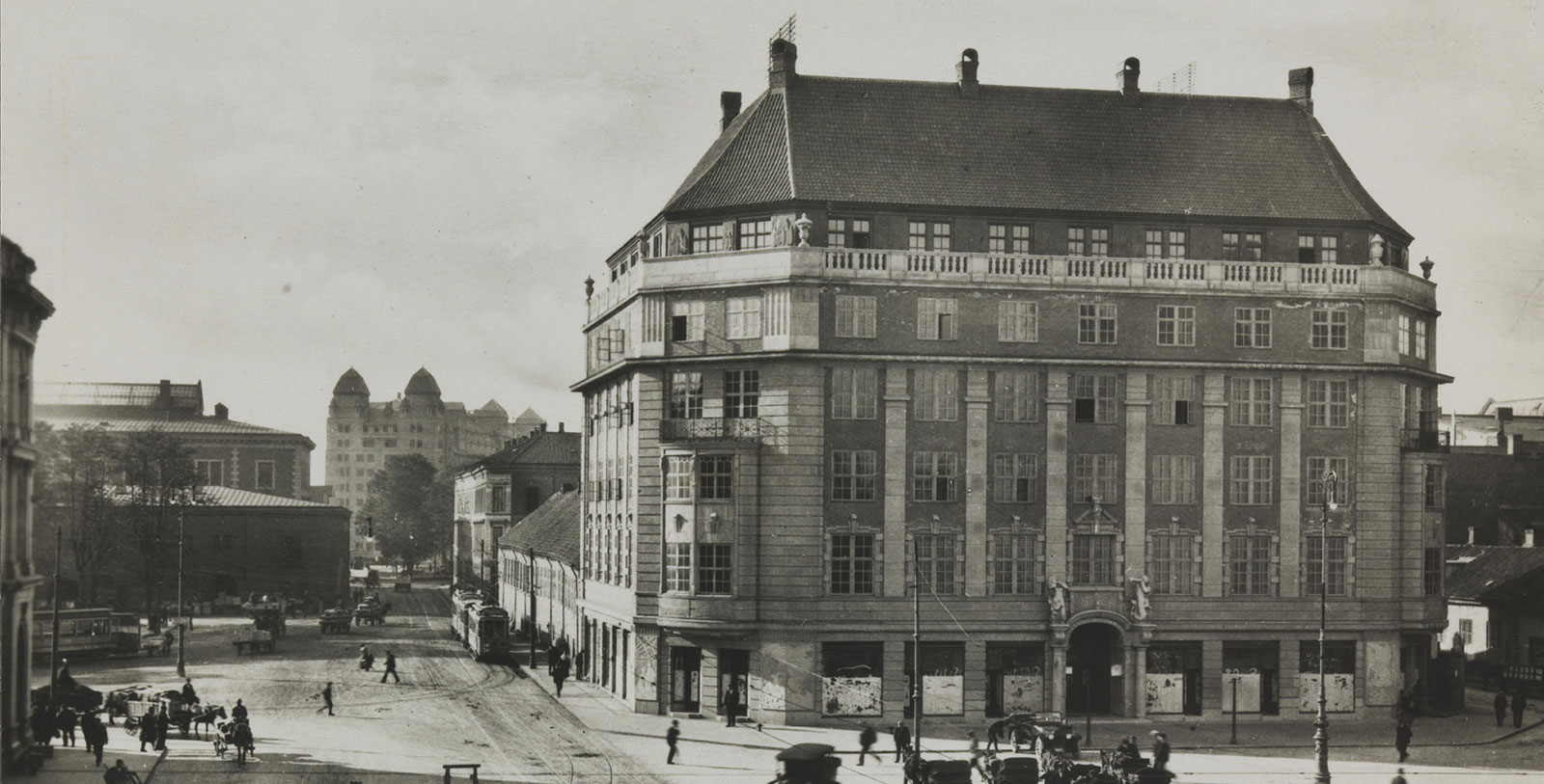 a large building with a street and cars on it