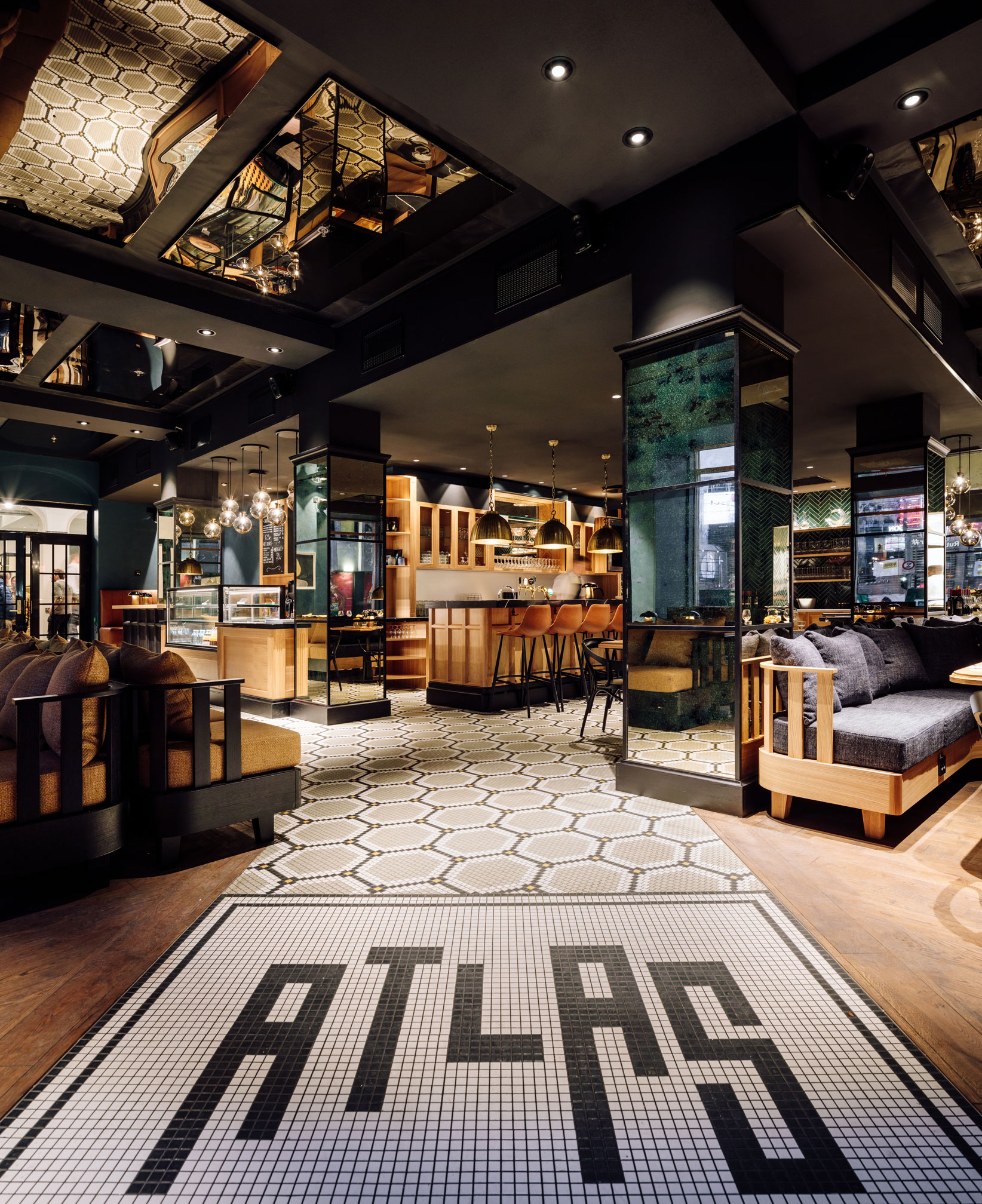 a room with a tile floor and a large area with tables and chairs