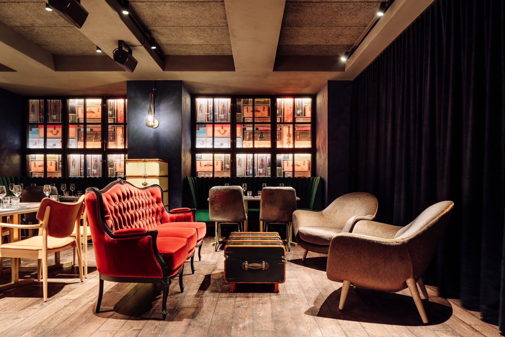 a room with a red couch and a suitcase