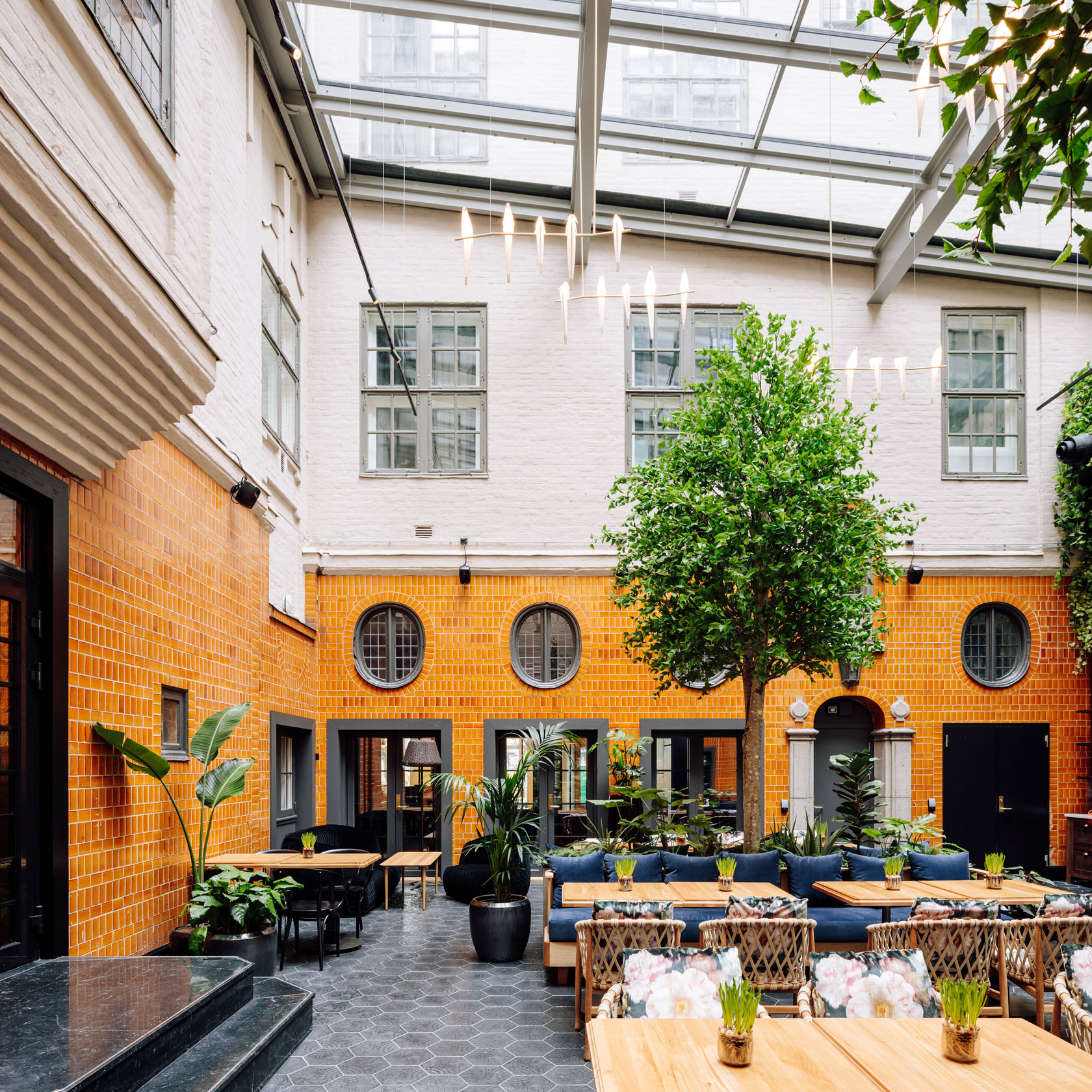 a room with tables and chairs in a courtyard