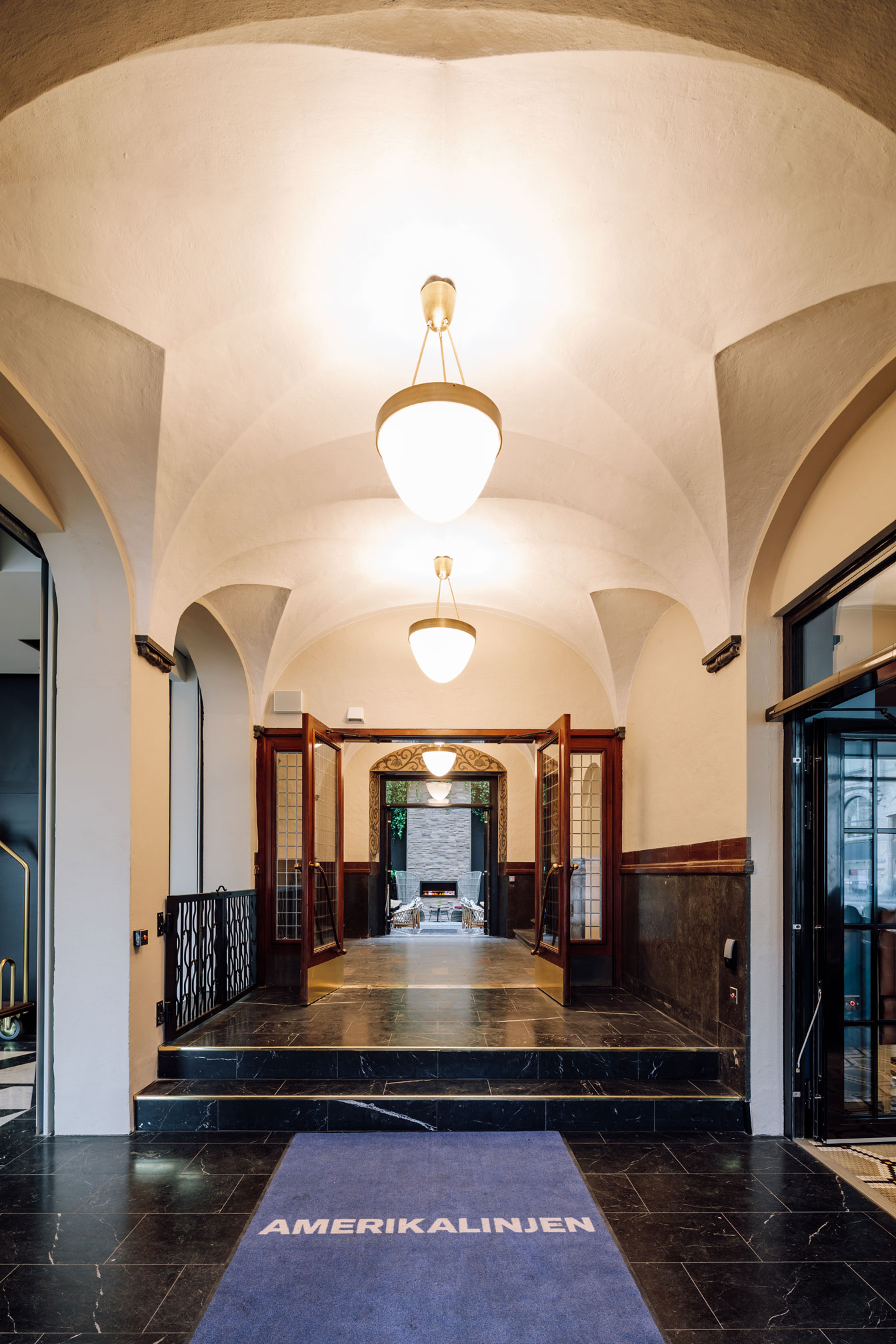 a hallway with a staircase and lights