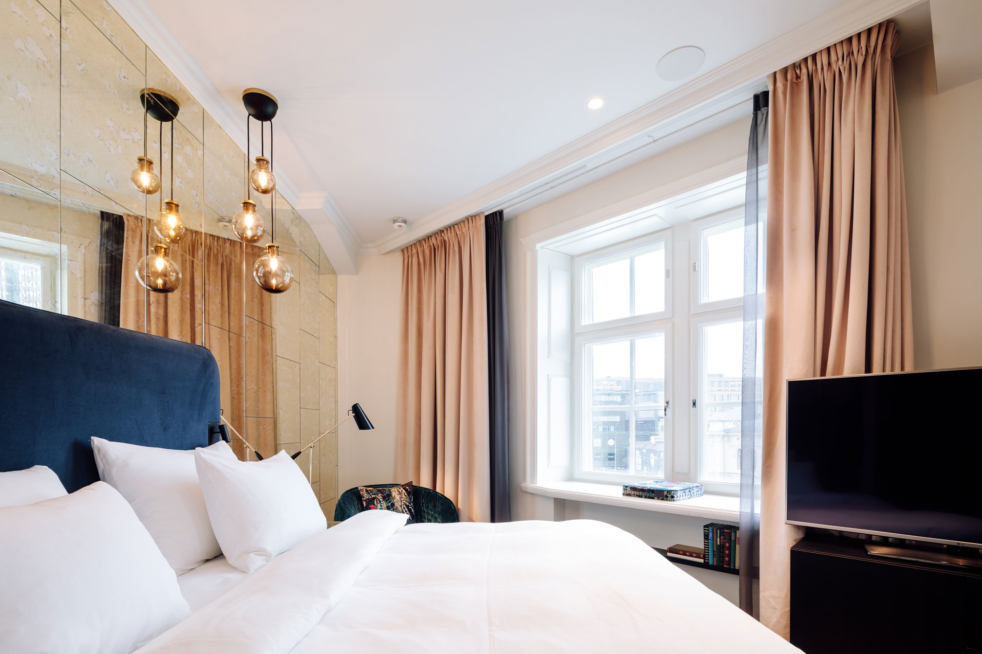 a bedroom with a bed and a tv