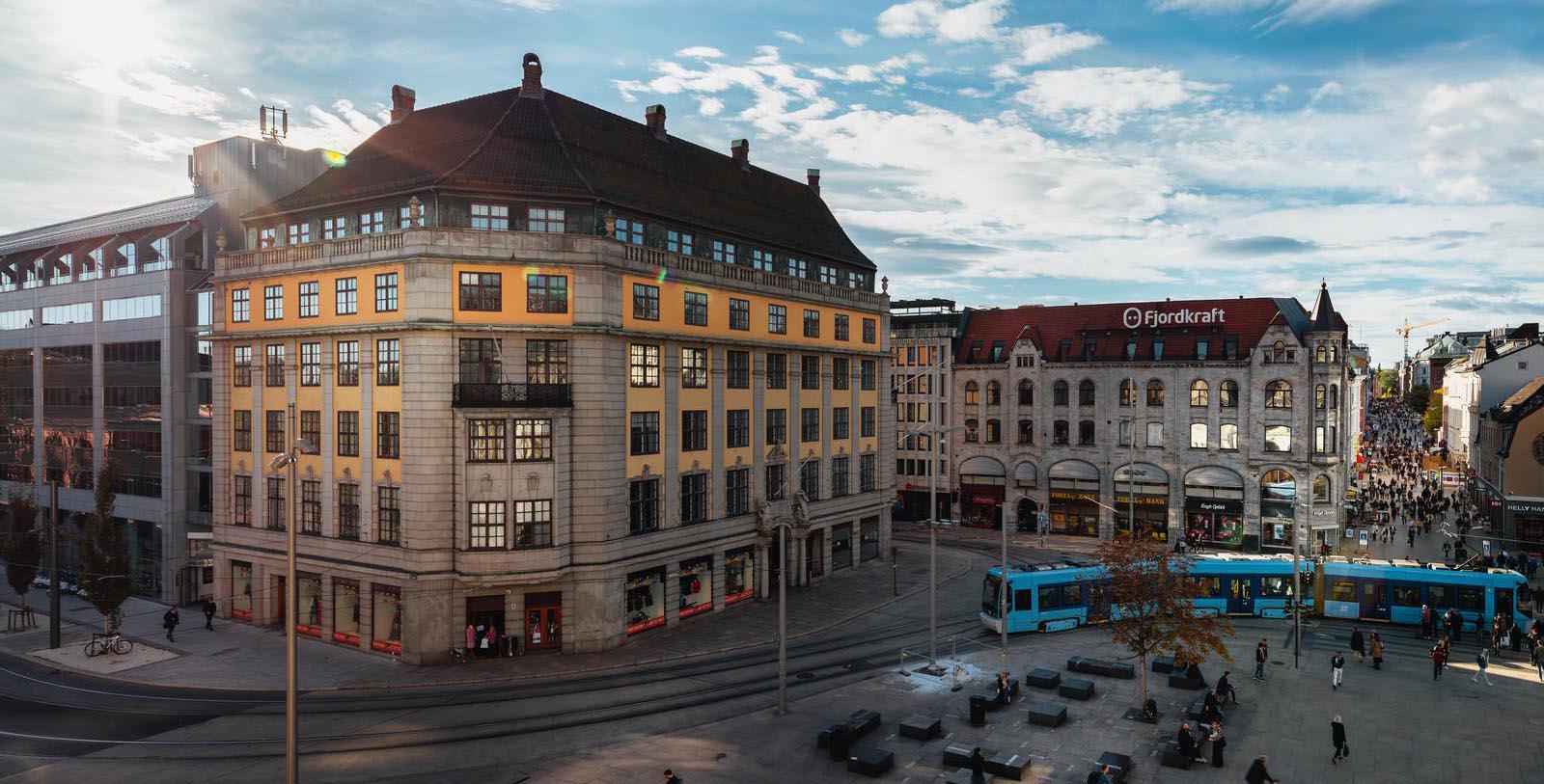 a large building with a bus in the middle of a city