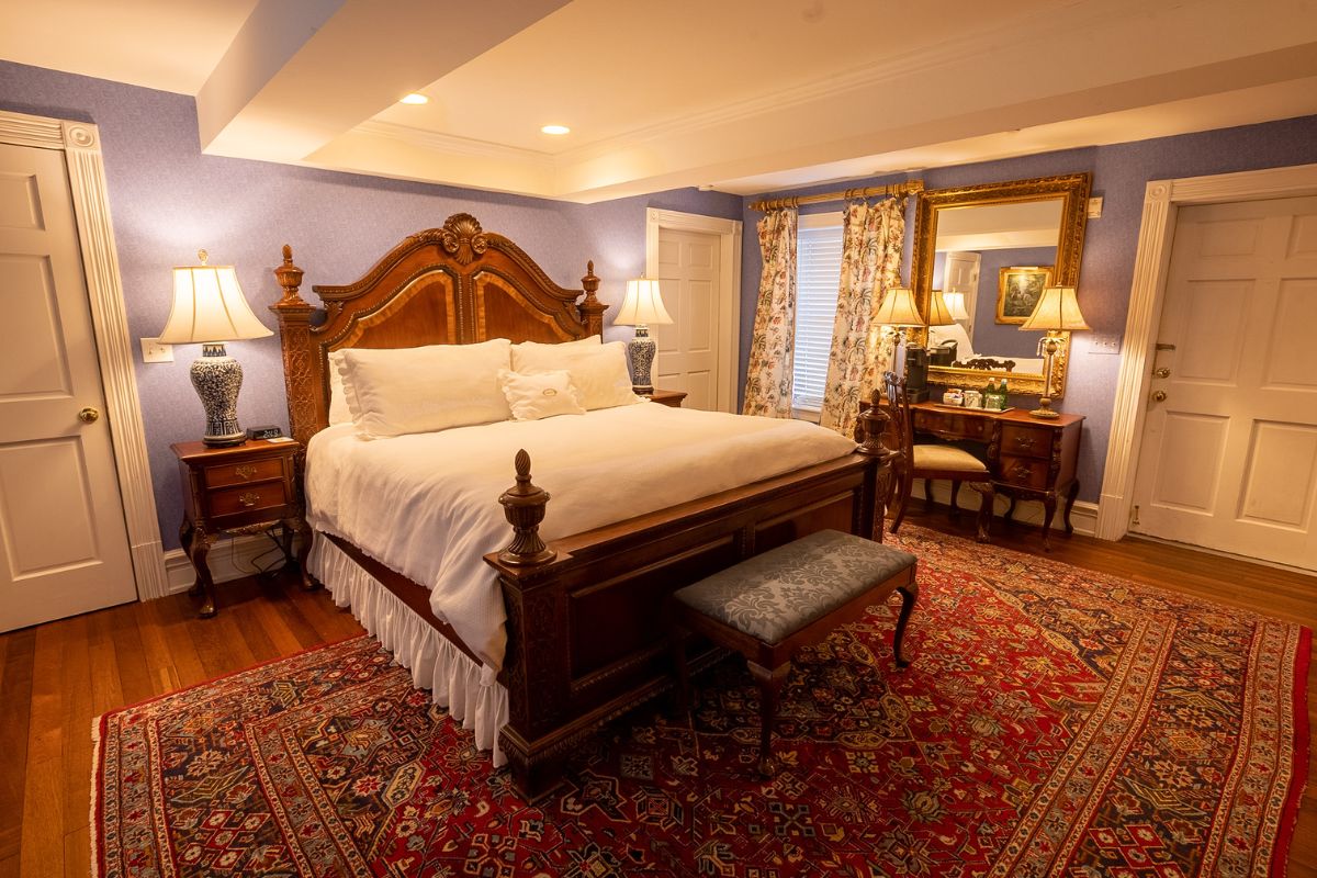 a bedroom with a bed and a mirror