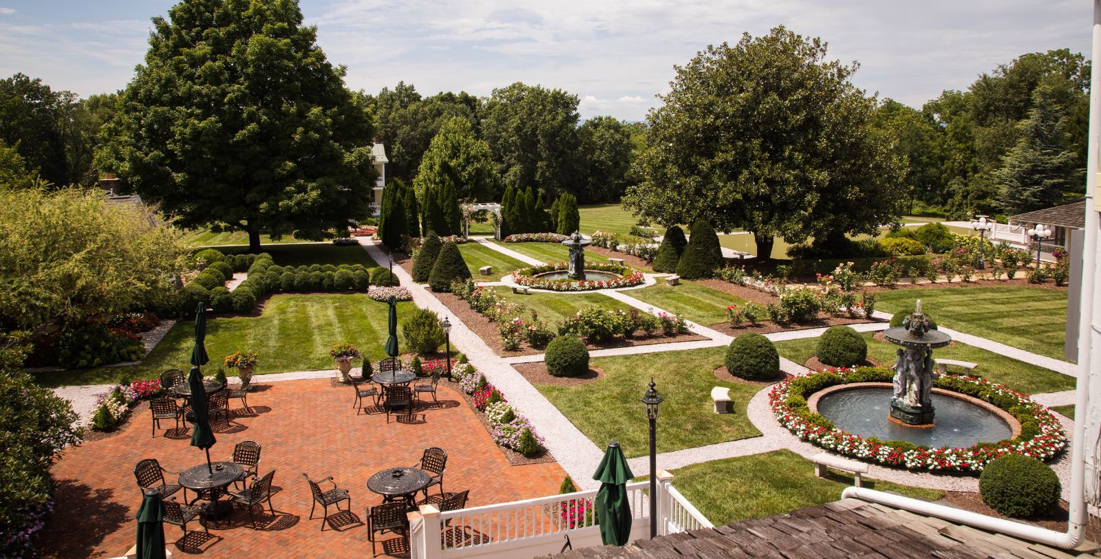 a garden with a fountain and trees