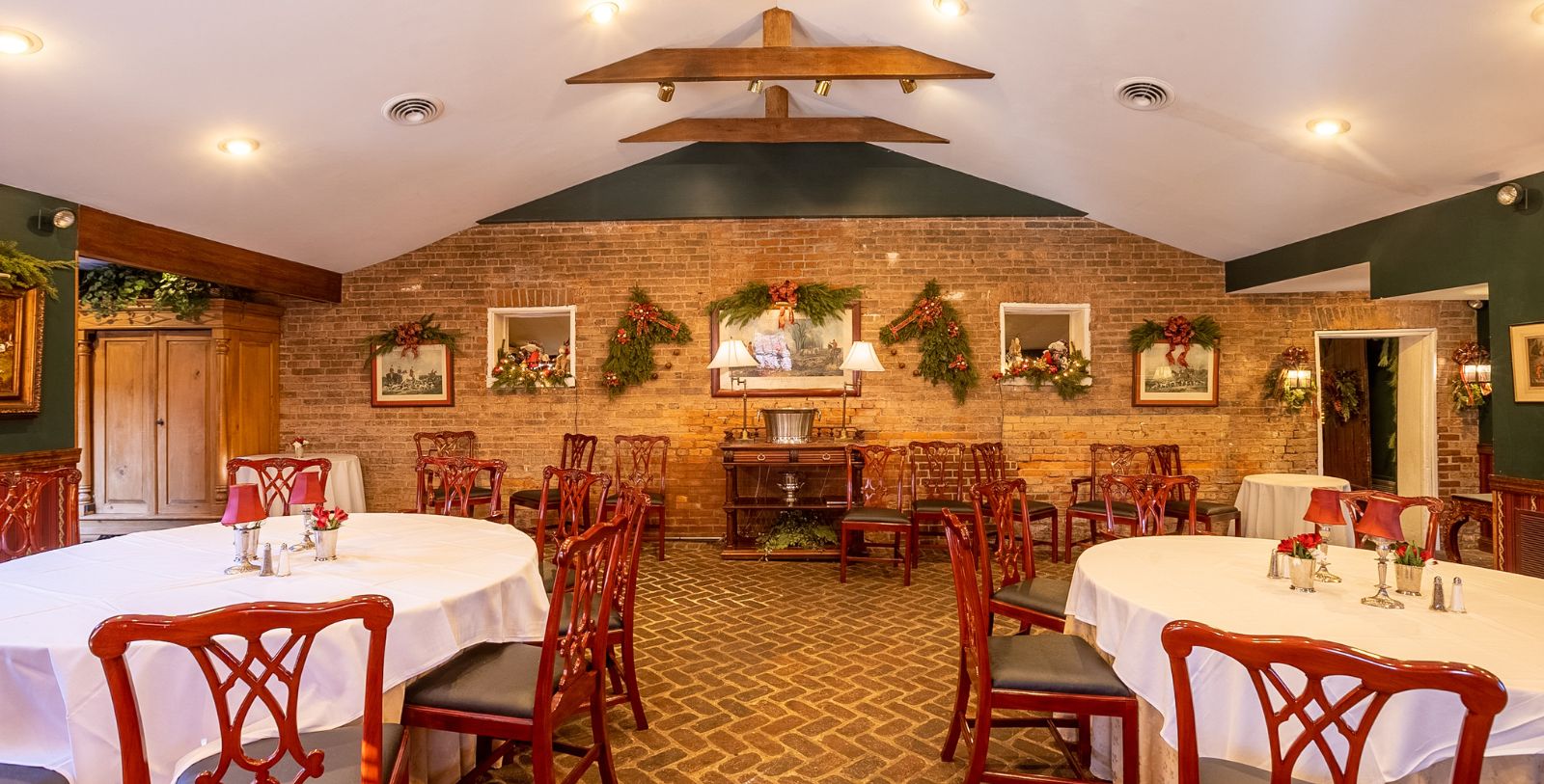 a room with a brick wall and tables and chairs
