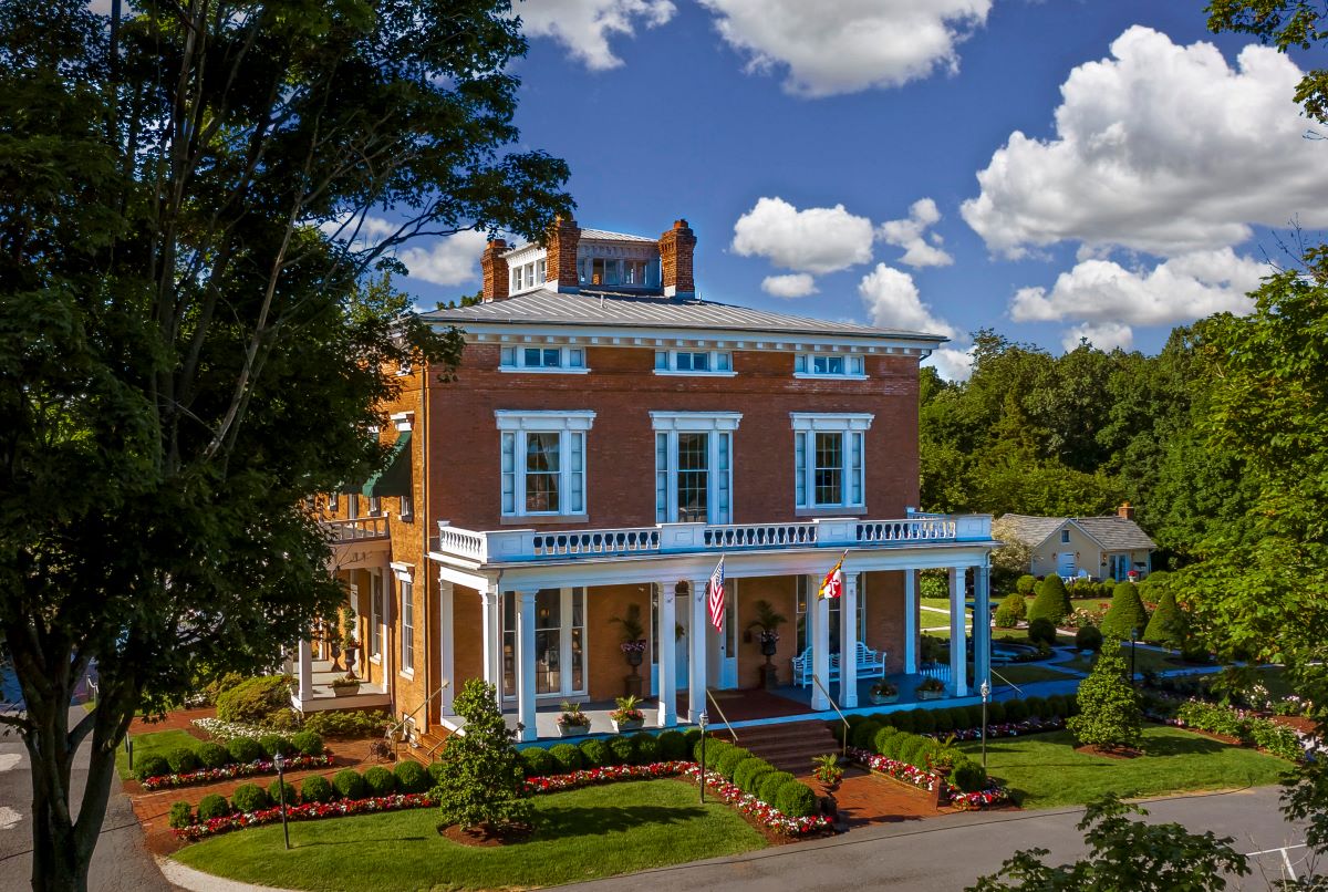 a large brick house with a large porch