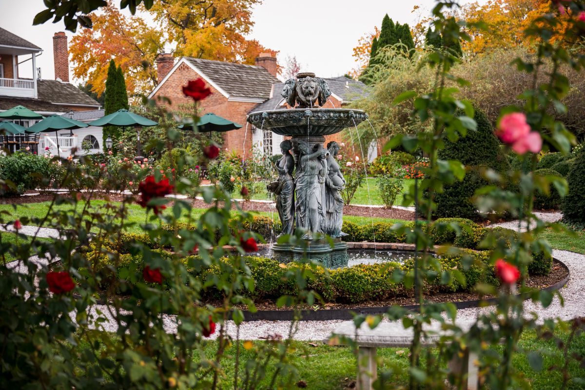 a fountain with statues in a garden