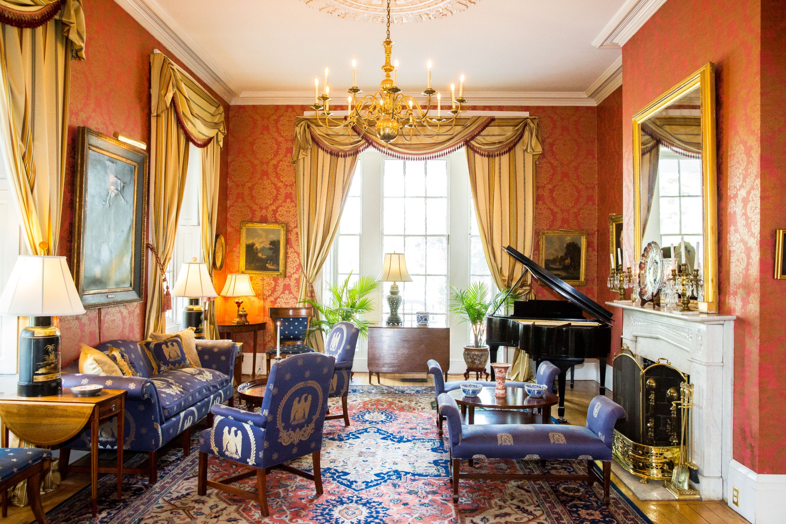 a room with a piano and chairs