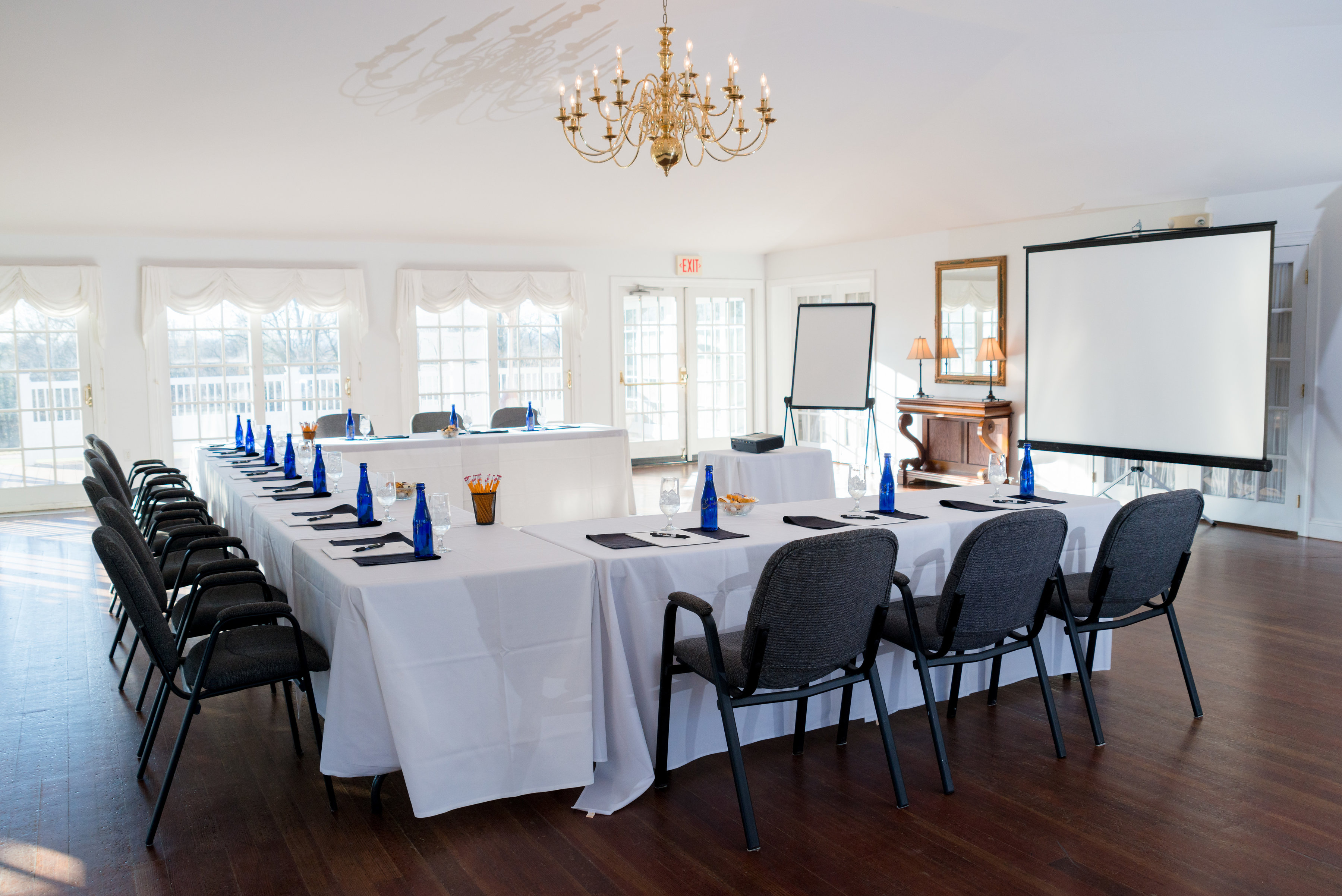 a room with a large table and chairs