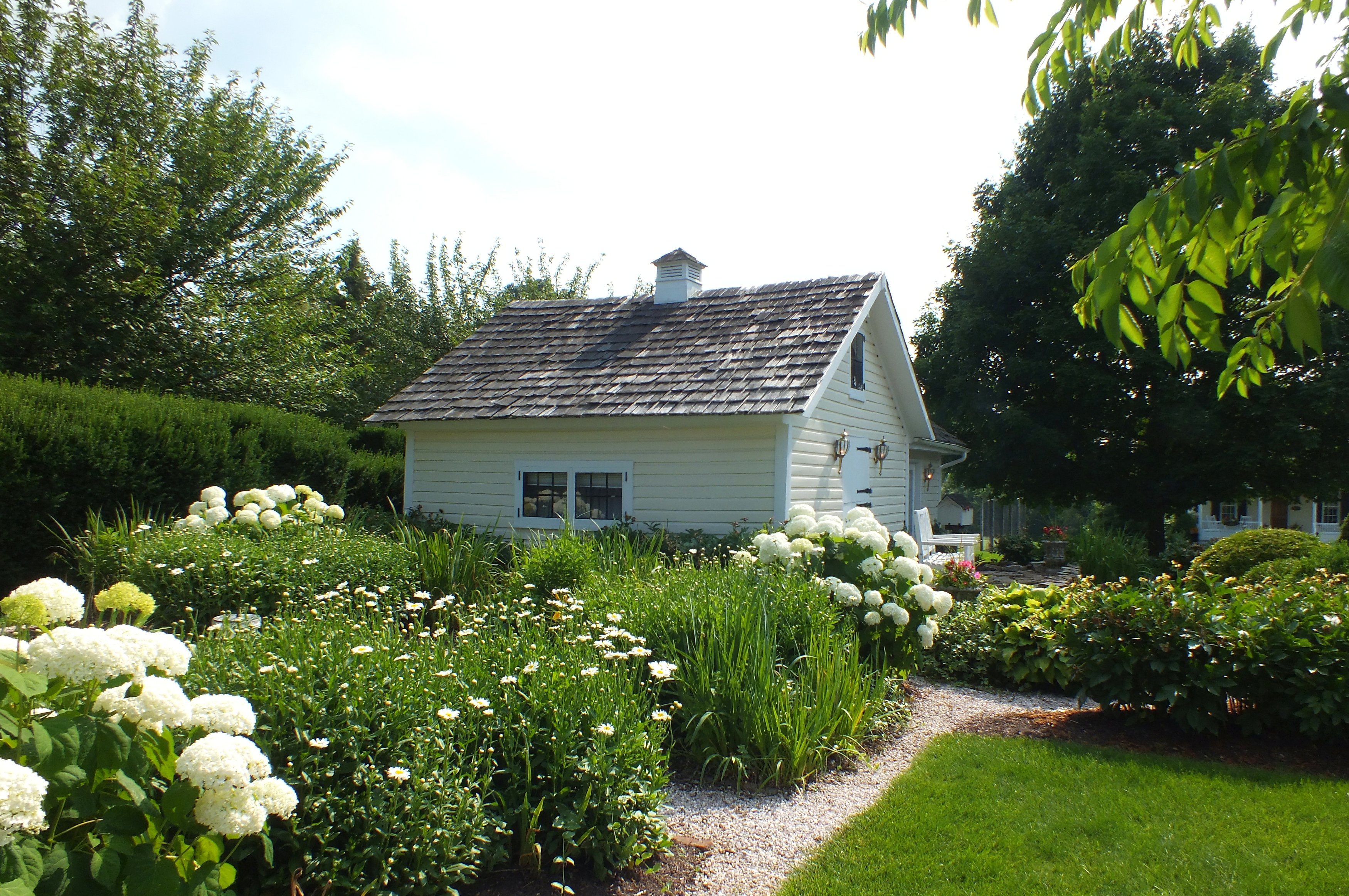 a white house with flowers in front of it