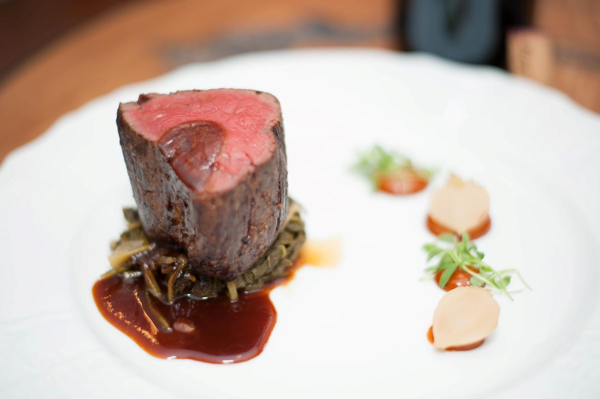 a piece of meat on a white plate