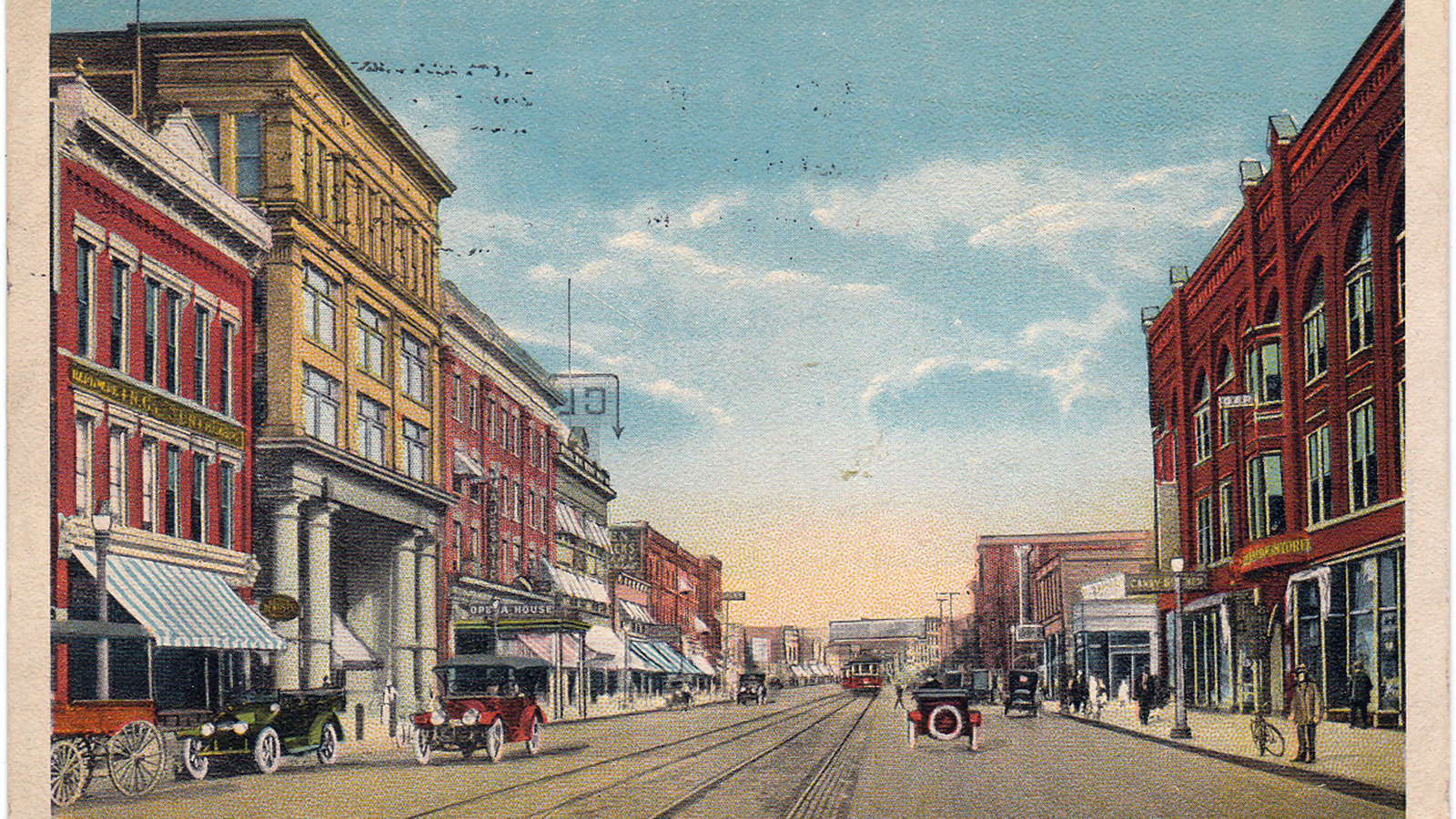 a city street with cars and buildings
