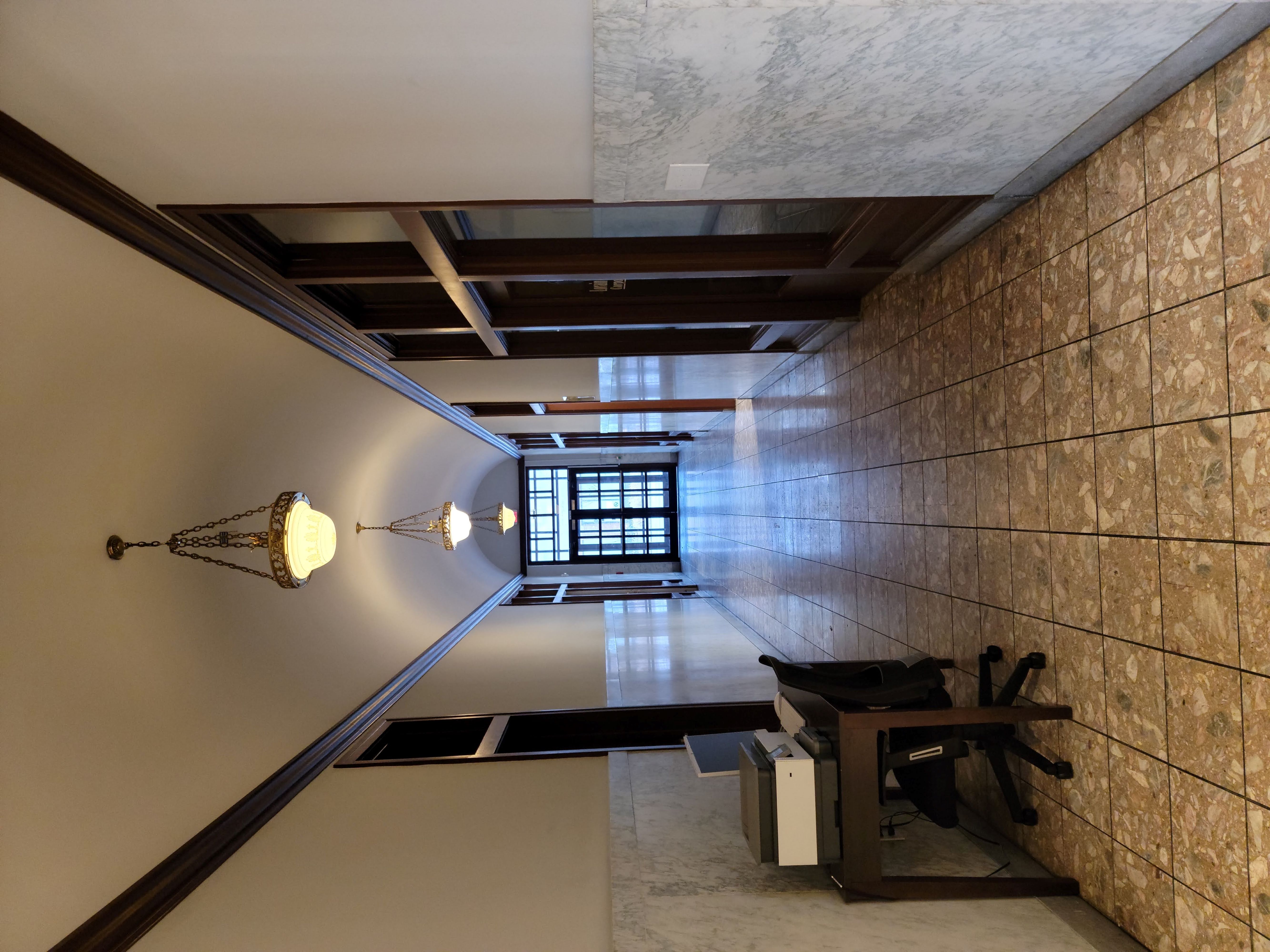 a hallway with a desk and a chair