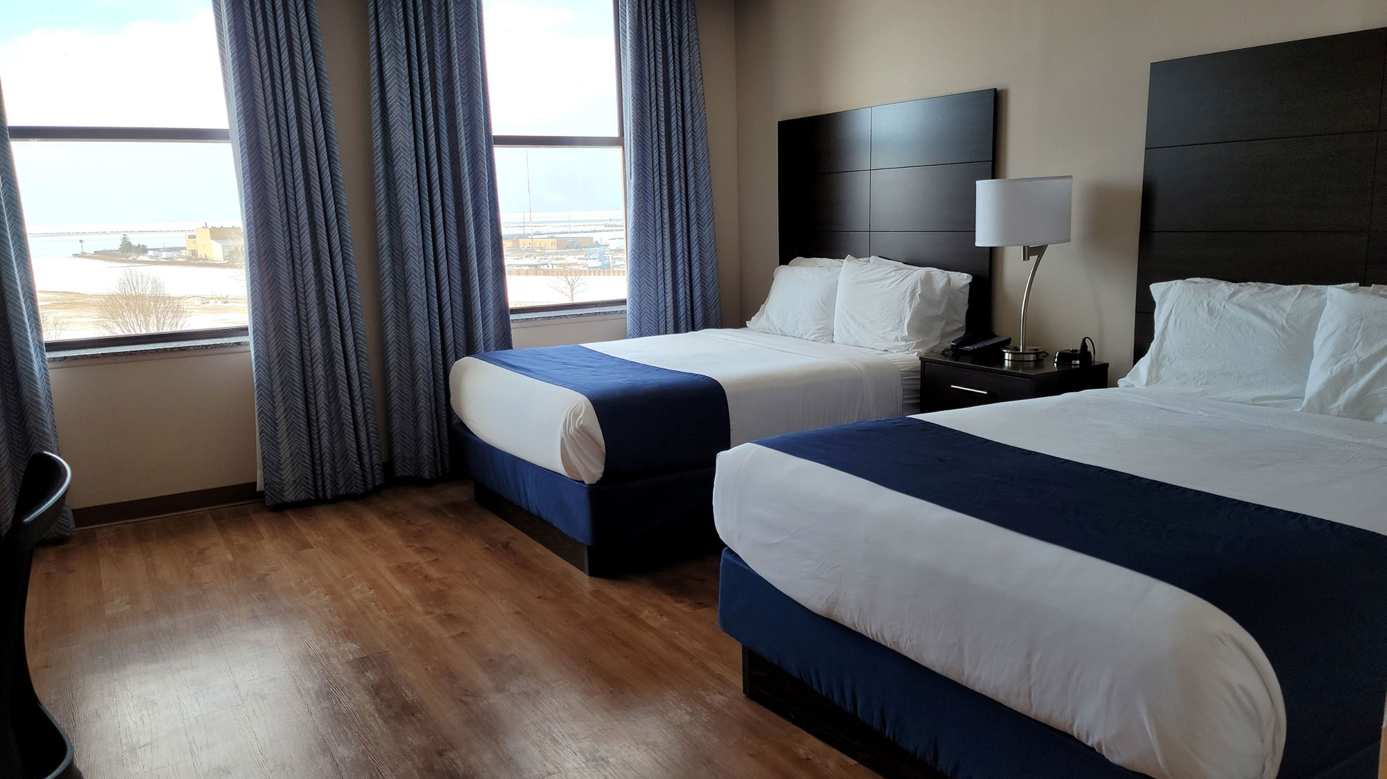 a room with two beds and a window