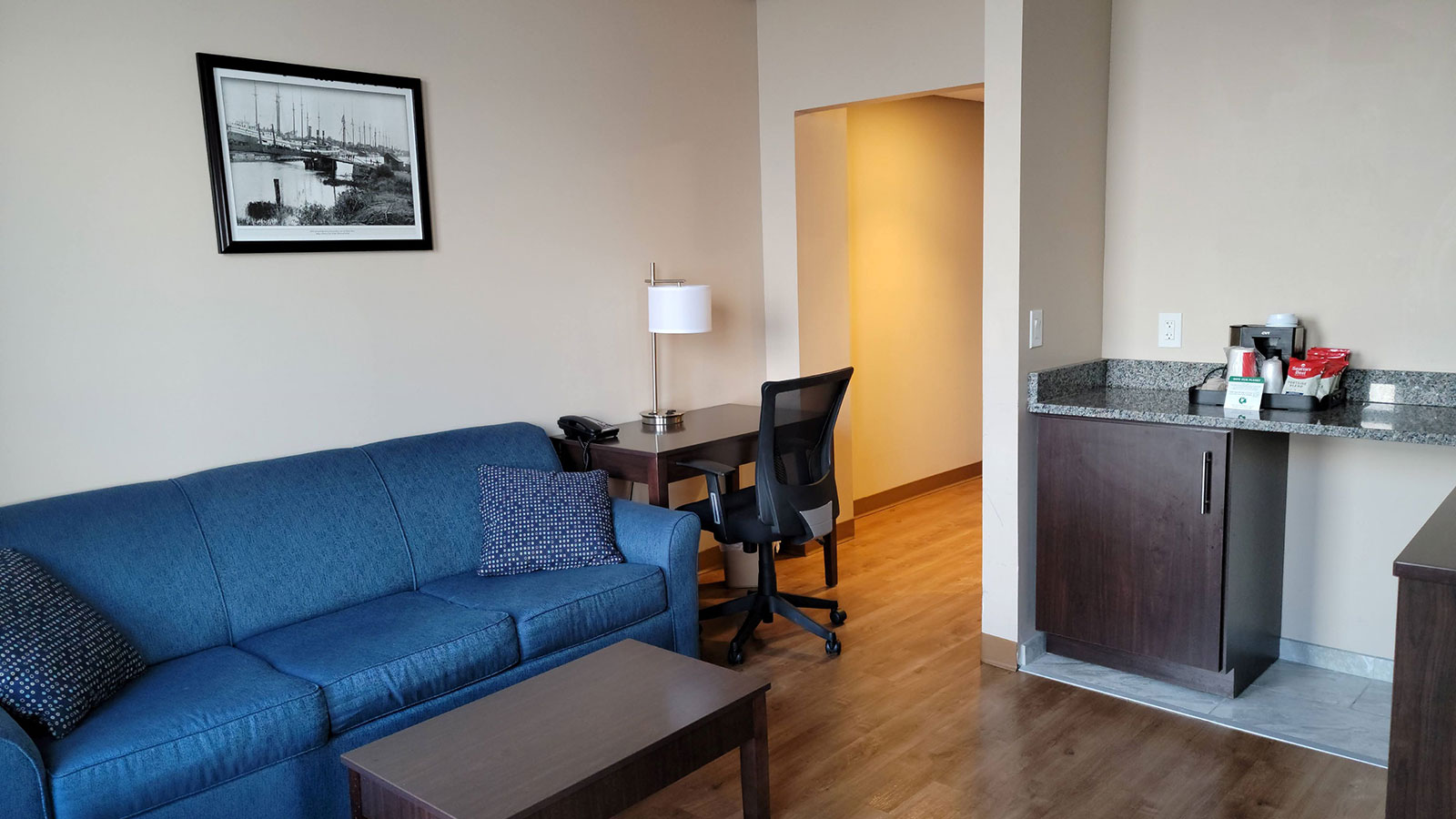 a living room with a couch and a desk