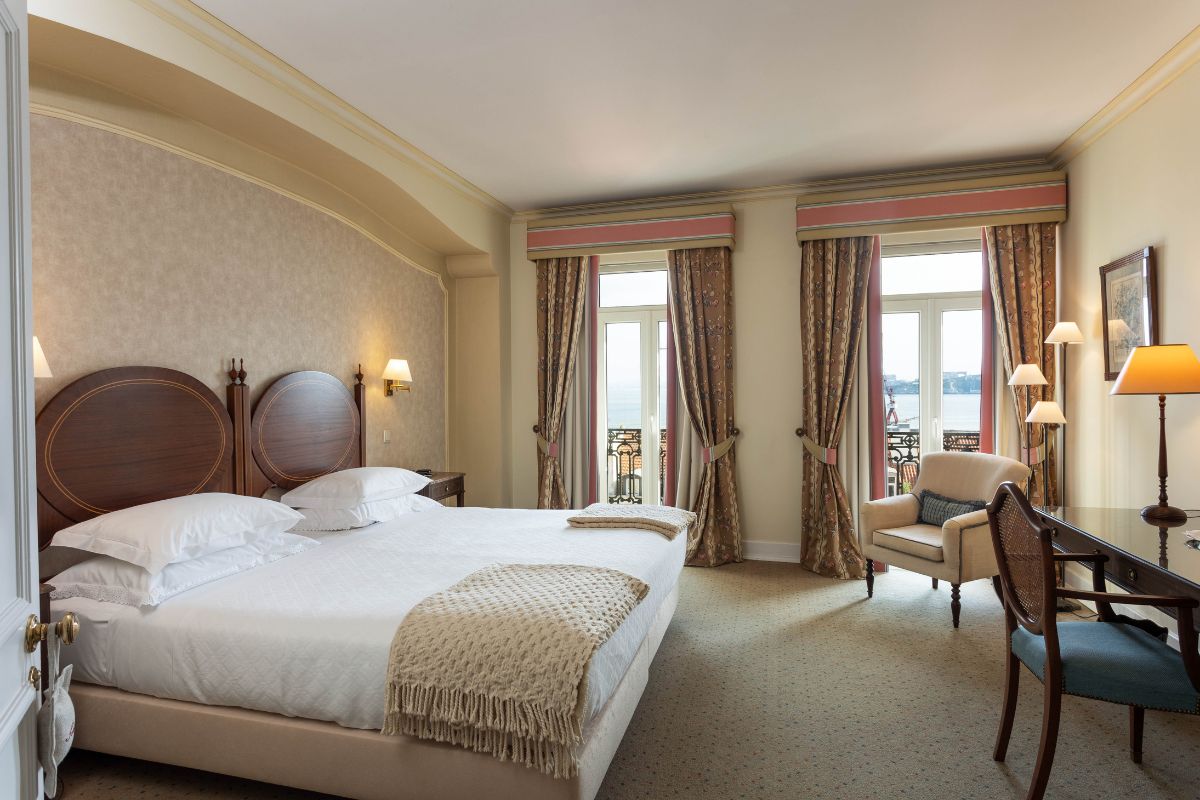 a room with a bed and chairs