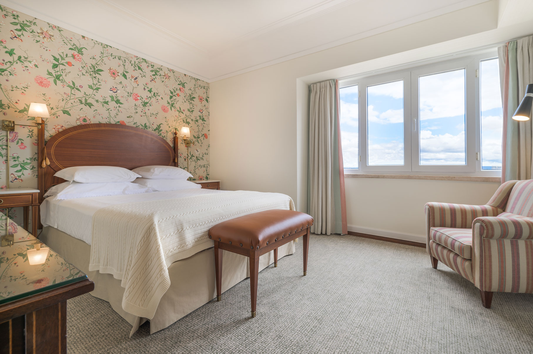 a bedroom with a bed and a chair