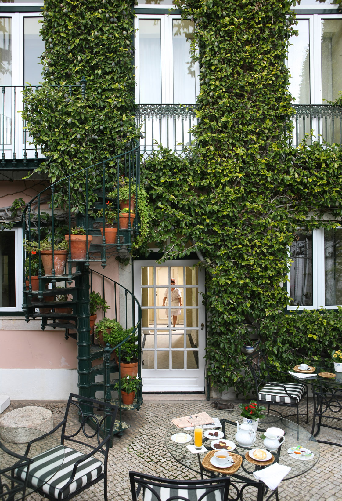 a house with a spiral staircase and a staircase with plants on it