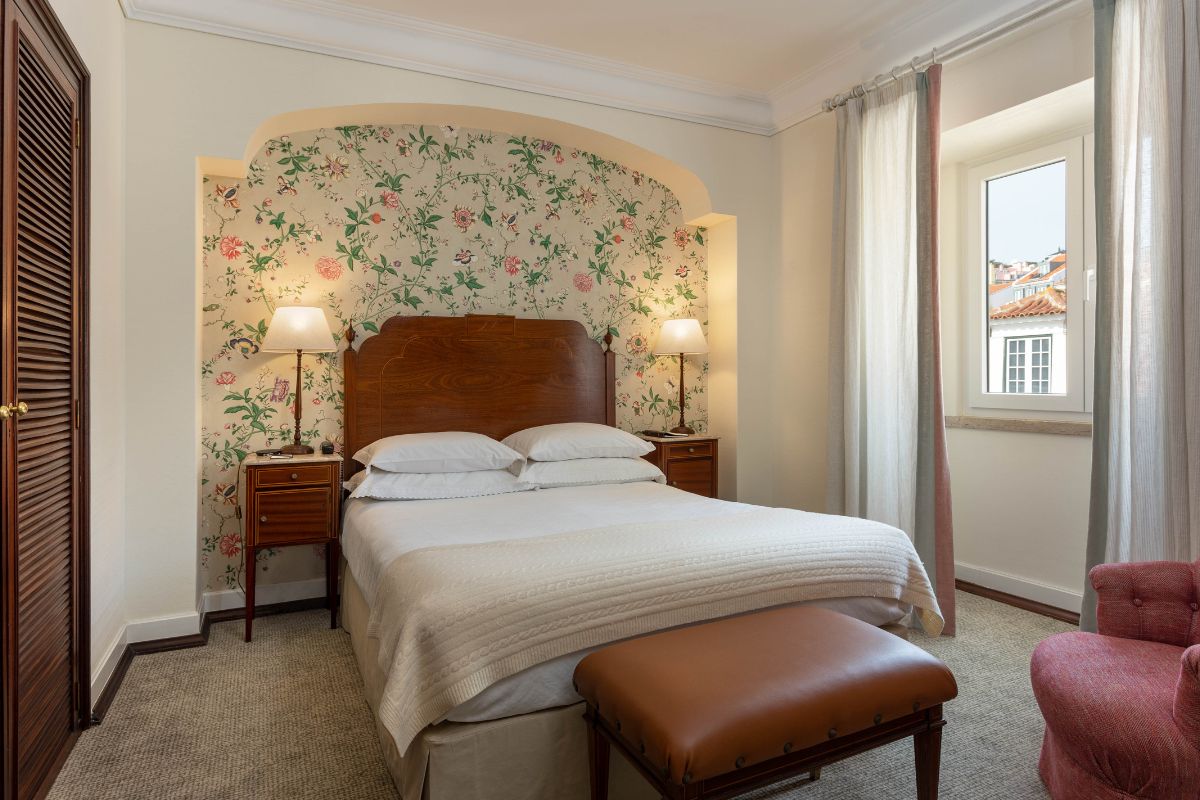 a bed with a bench in a room